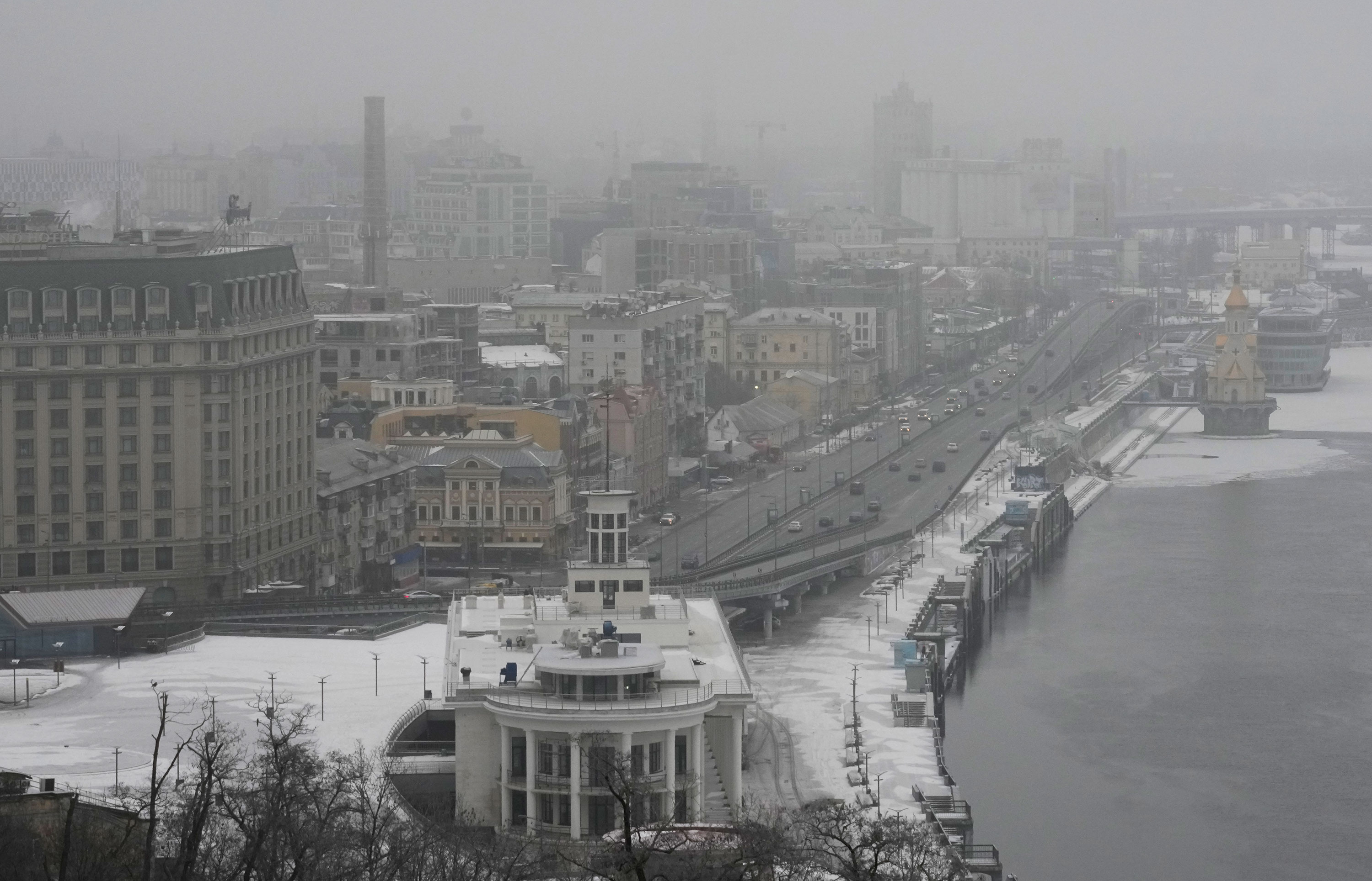Fog covers Kyiv city center Saturday. A series of explosions rocked the city Saturday morning and minutes later air raid sirens started to wail. 