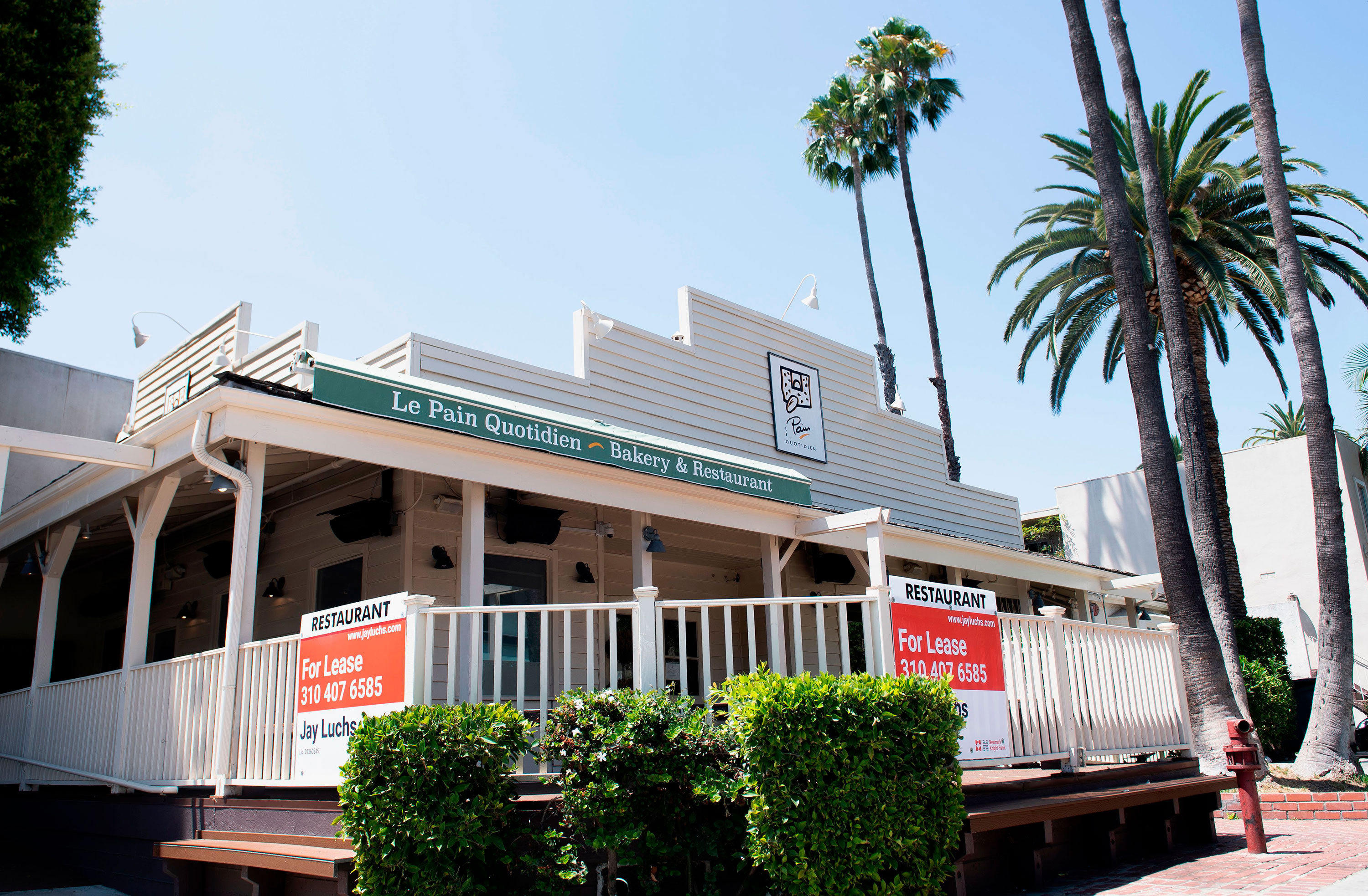 For Lease signs are seen on the balcony of a now closed restaurant in West Hollywood, California on August 3.