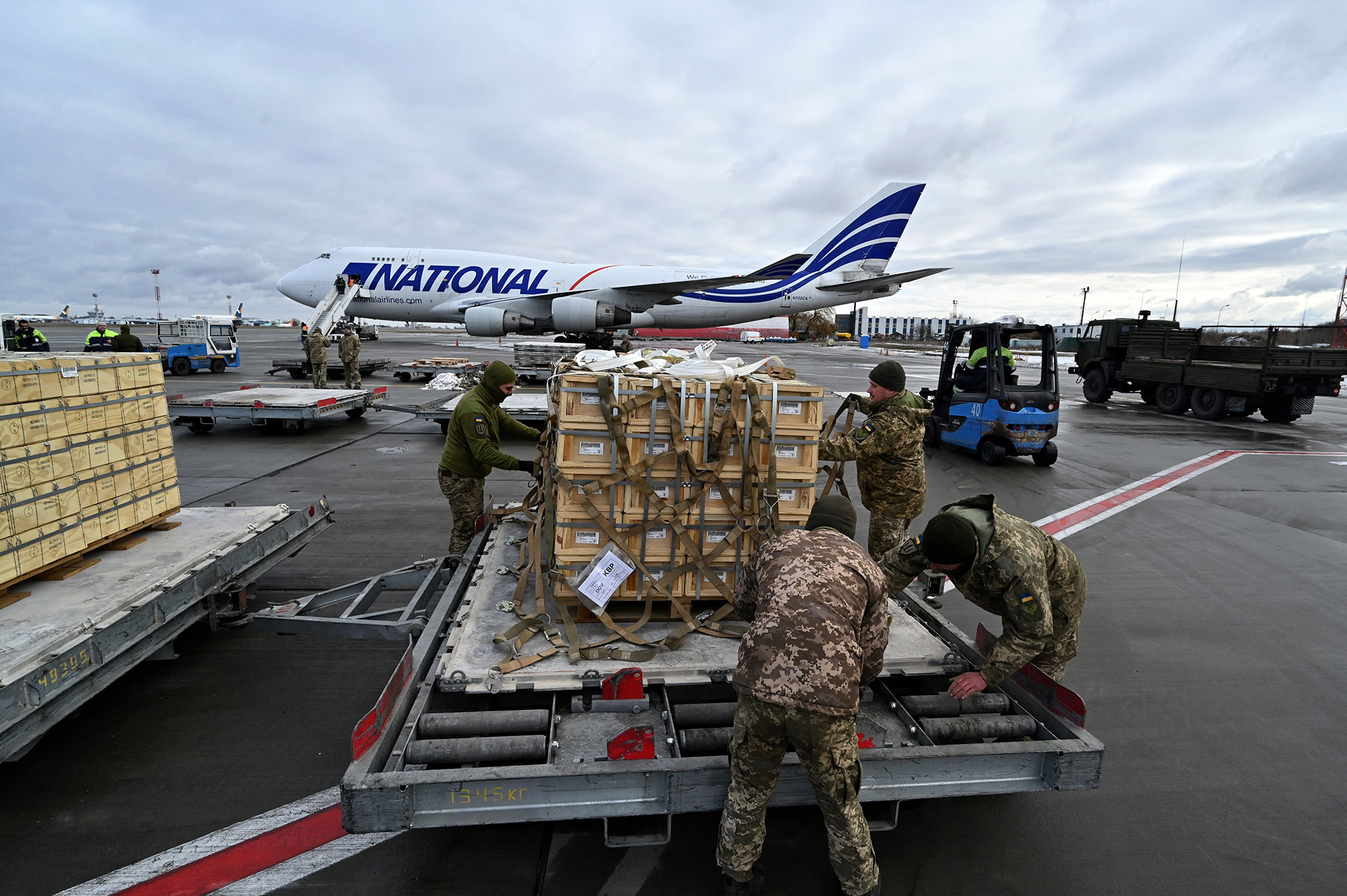 Ukrainian military servicemen unload a Boeing 747-412 carrying US military aid at Kyiv's Boryspil airport, Ukraine, on February 9, 2022.