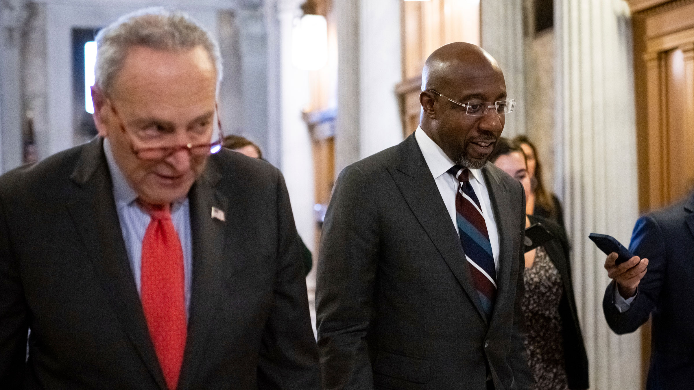 US Sen. Raphael Warnock, right, speaks to the media as he walks with Senate Majority Leader Chuck Schumer at the US Capitol on Wednesday.