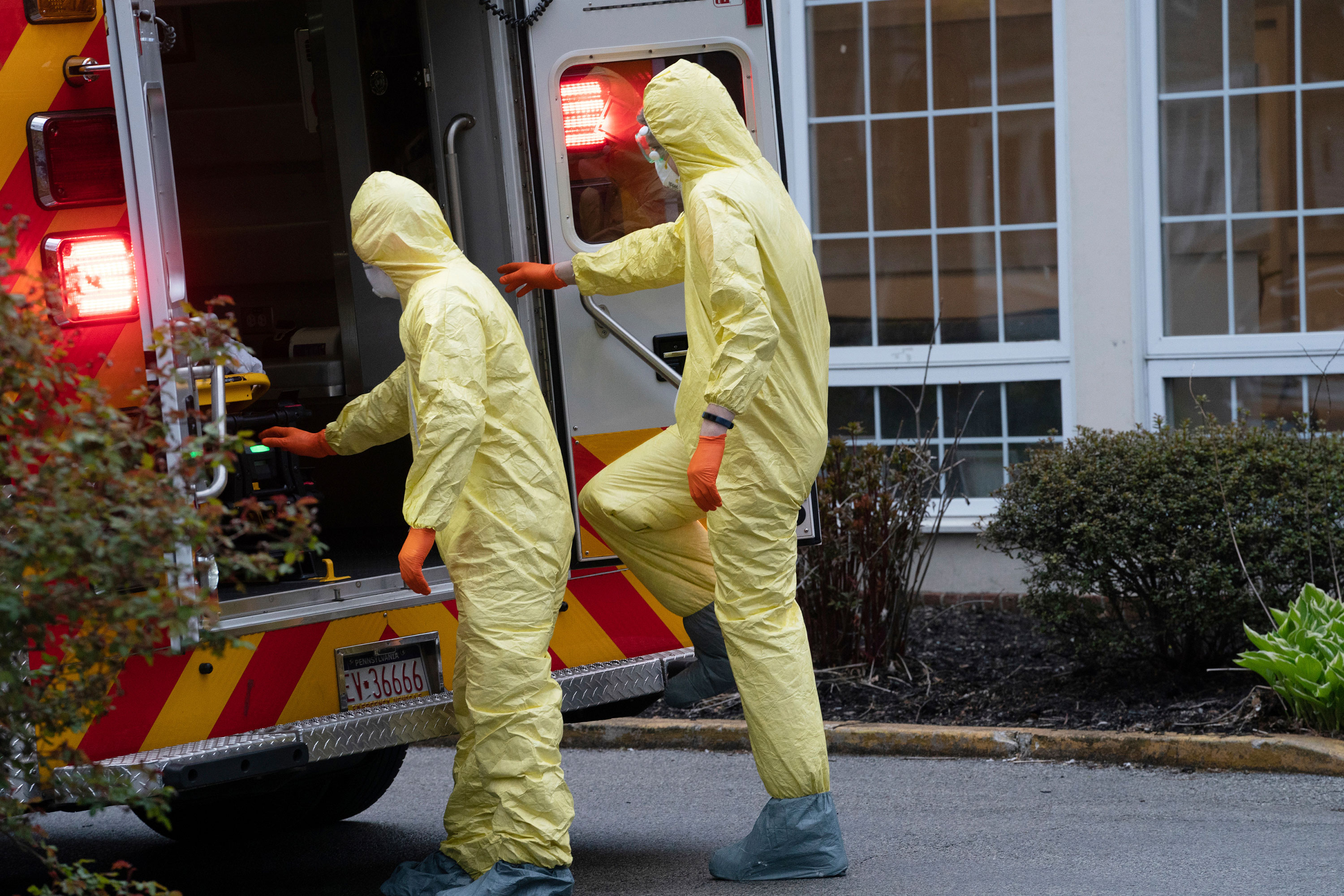 Paramedix full personal protective equipment (PPE) during a call at a nursing home in Bryn Mawr, Pa. The company responds to 911 calls across five towns that straddle Montgomery and Delaware Counties: Lower Merion, Narberth, Haverford, Conshohocken, and West Conshohocken. (Jessica Griffin/The Philadelphia Inquirer via AP)