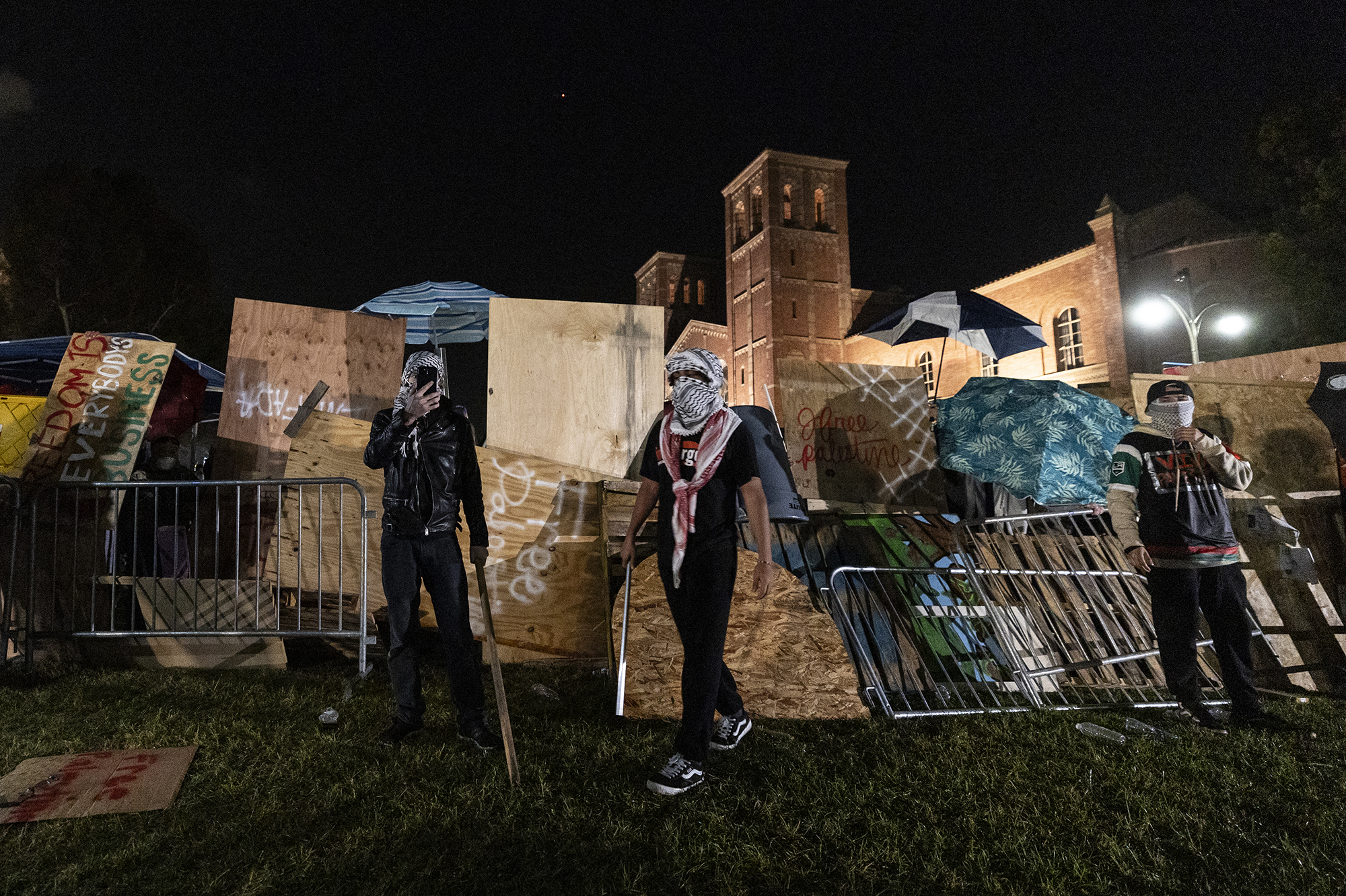 Pro-Palestinian demonstrators regroup and rebuild the barricade surrounding the encampment set up on the campus of the University of California Los Angeles (UCLA) as clashes erupt with counter protesters, in Los Angeles on May 1.