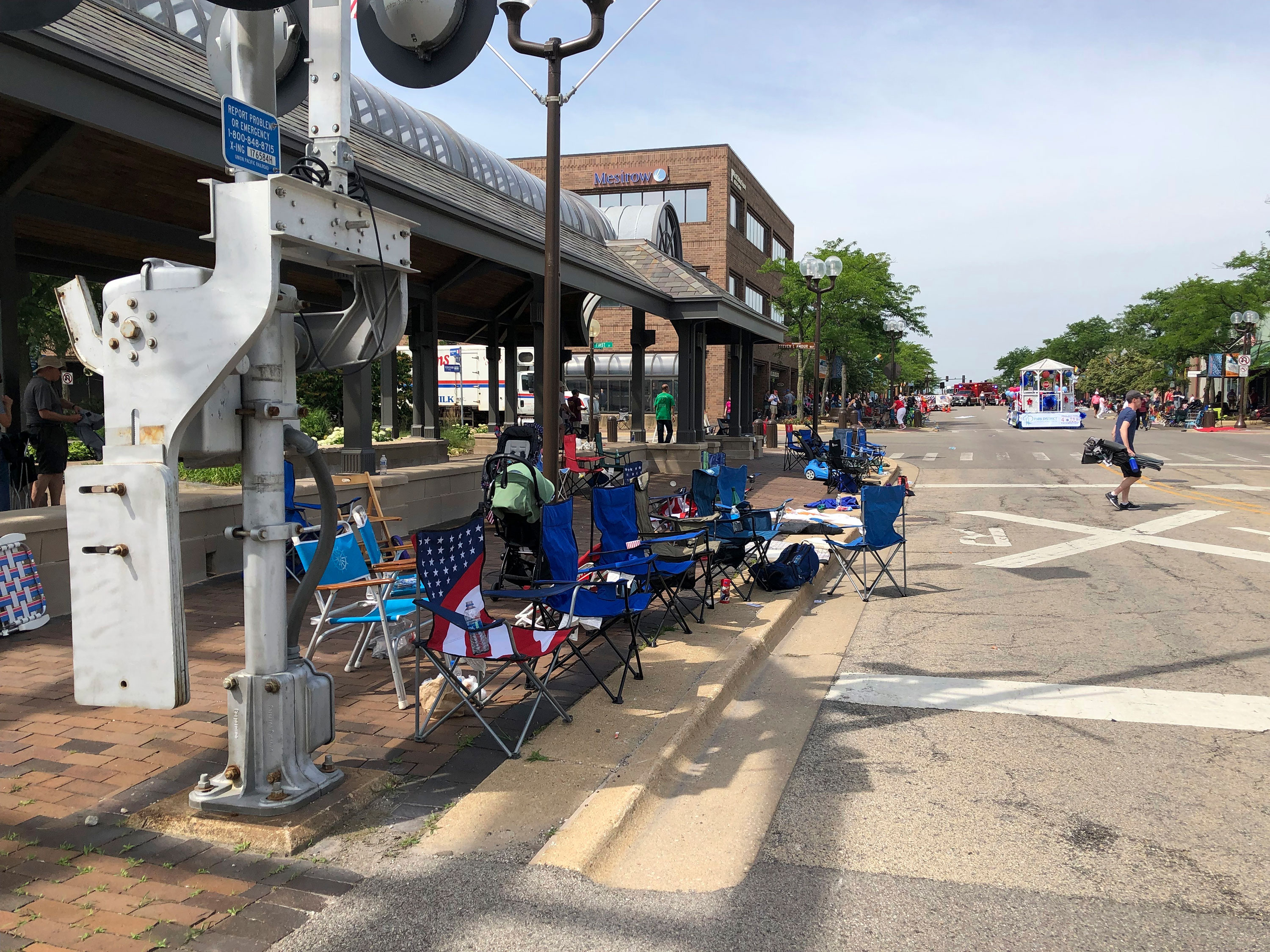 Empty chairs sit along the sidewalk after parade-goers fled Highland Park, Illinois', Fourth of July parade after shots were fired on Monday.