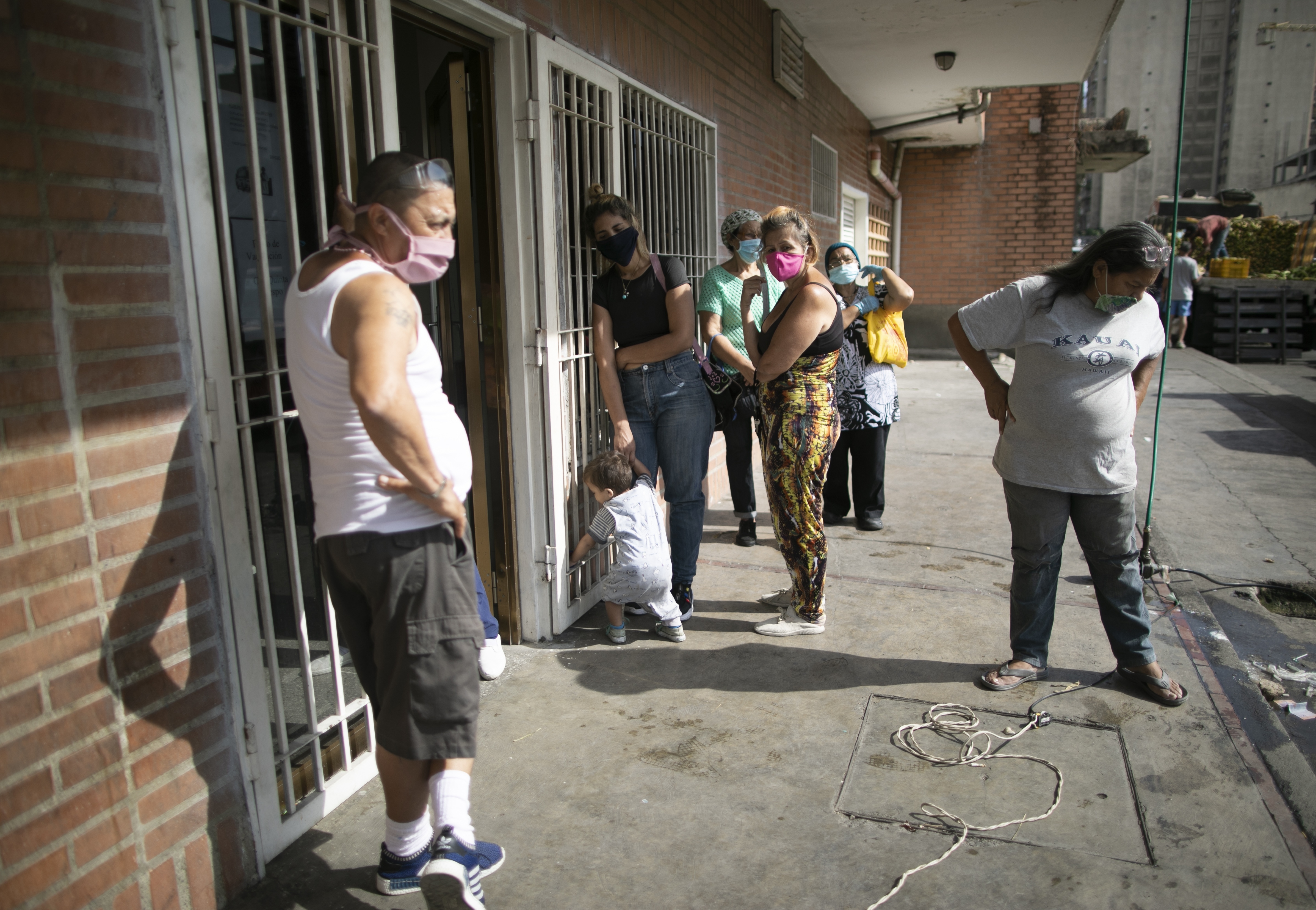 People wait to get a coronavirus test outside a diagnosis center in Caracas, Venezuela, on April 10.