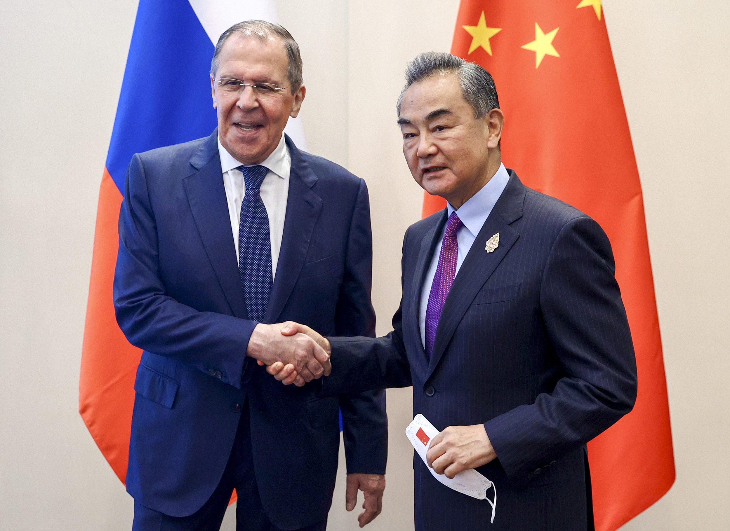 Russian Foreign Minister Sergey Lavrov, left, shakes hands with Chinese Foreign Minister Wang Yi during their bilateral meeting ahead of the G20 Foreign Ministers' Meeting in Nusa Dua, Bali, Indonesia, on July 7.