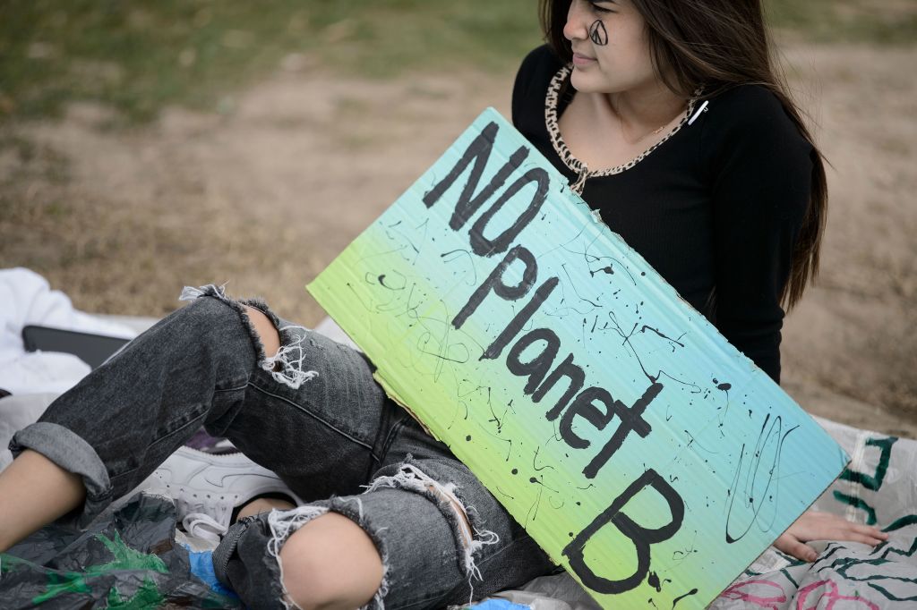 An activist sits during a youth climate rally on the west front of the US Capitol on March 15, 2019 in Washington, DC. 