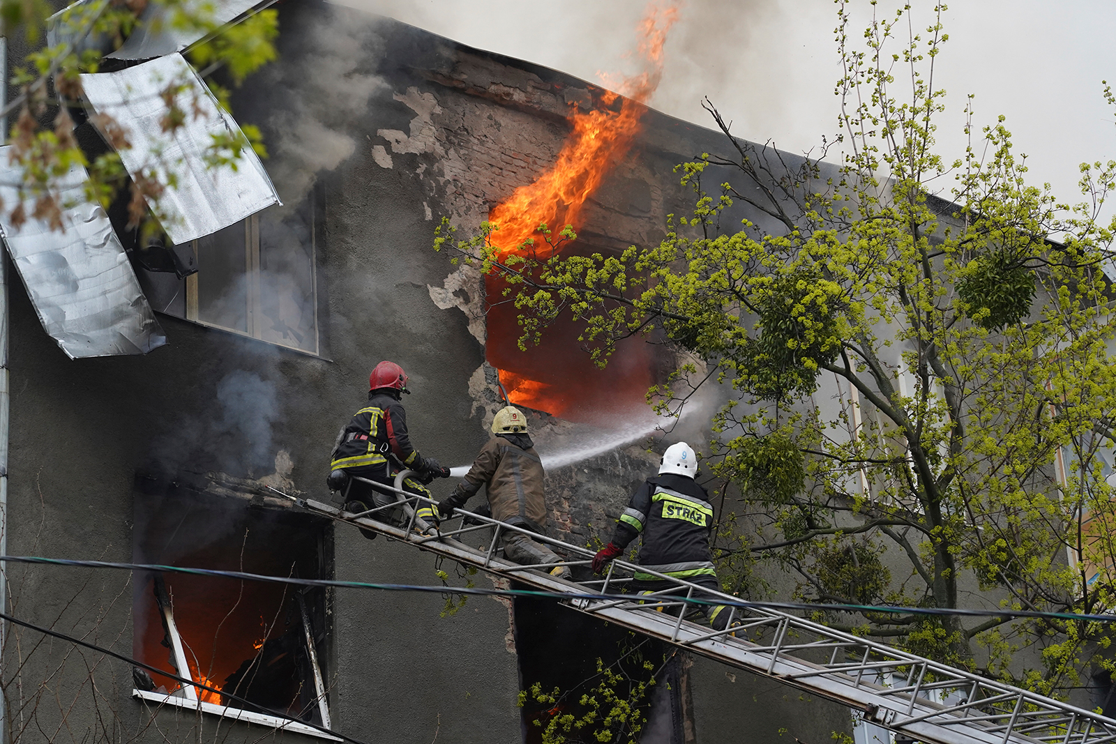 Firefighters work to extinguish fire at an apartments building after a Russian attack in Kharkiv, Ukraine, Sunday, April 17. 
