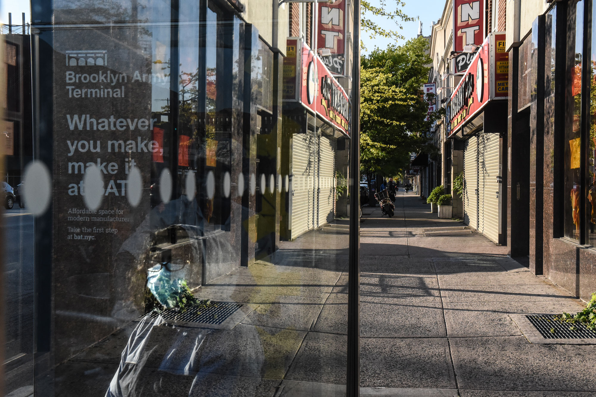 A person wearing a protective mask waits at a bus stop on May 13 in the Brooklyn borough in New York City. 