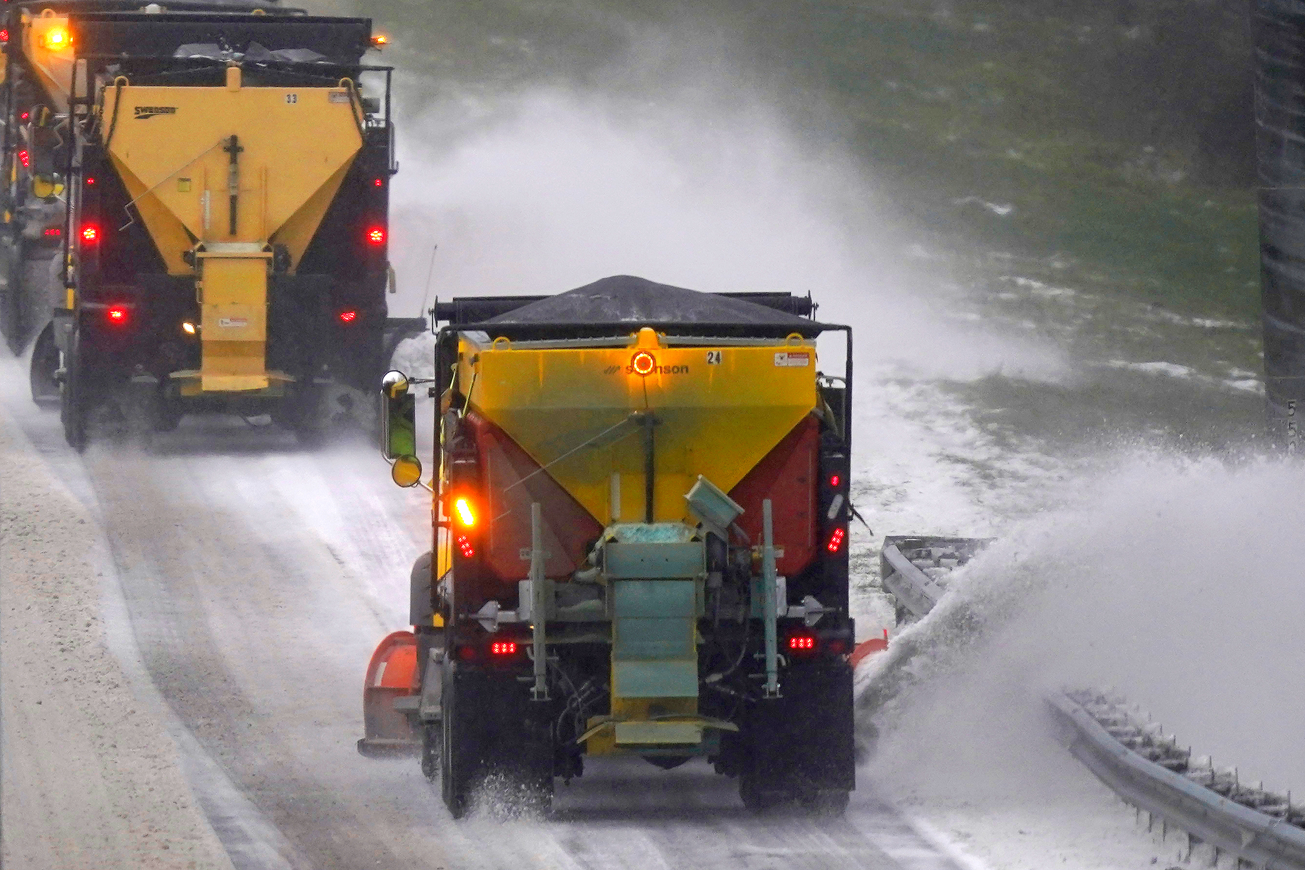 Snow plows remove snow and ice from an interstate in Hillsborough, North Carolina, on Sunday, January 16. 