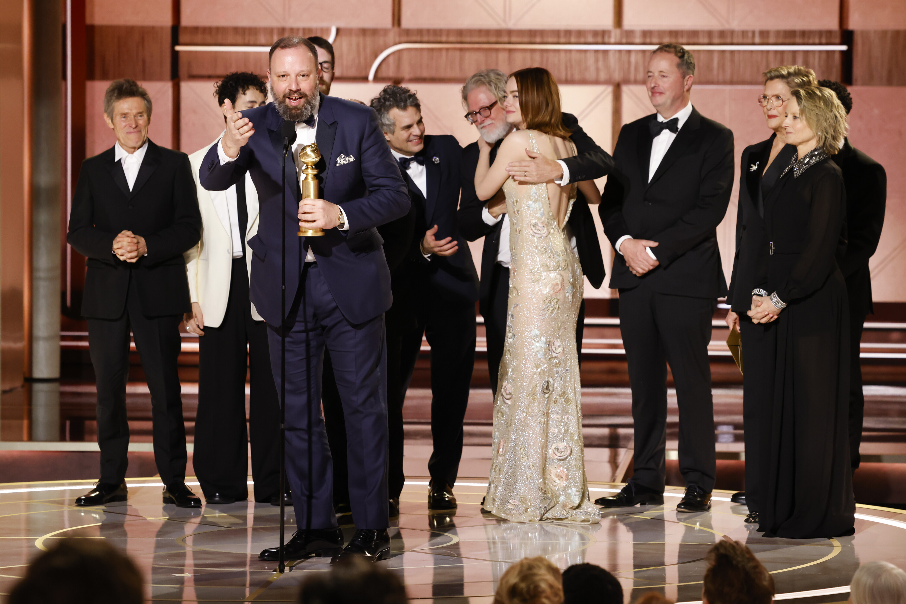 Yorgos Lanthimos accepts the Golden Globe for best musical or comedy motion picture, along with the cast of “Poor Things.” 