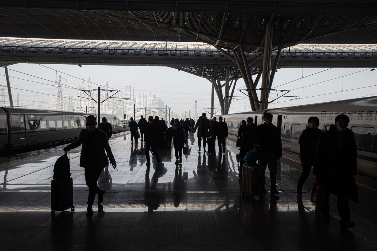 Passengers walk on a platform after arriving at the railway station in Wuhan, China on December 28.
