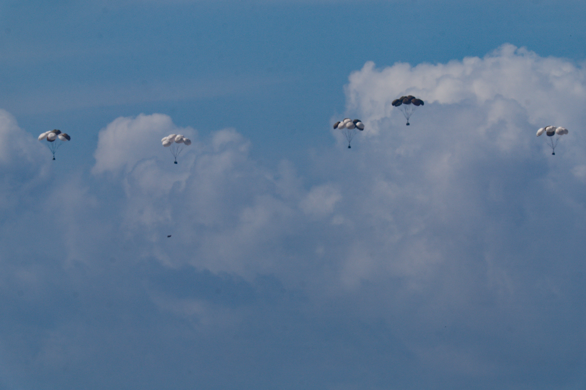 Aid packages fall towards northern Gaza after being dropped from a military aircraft on Saturday.