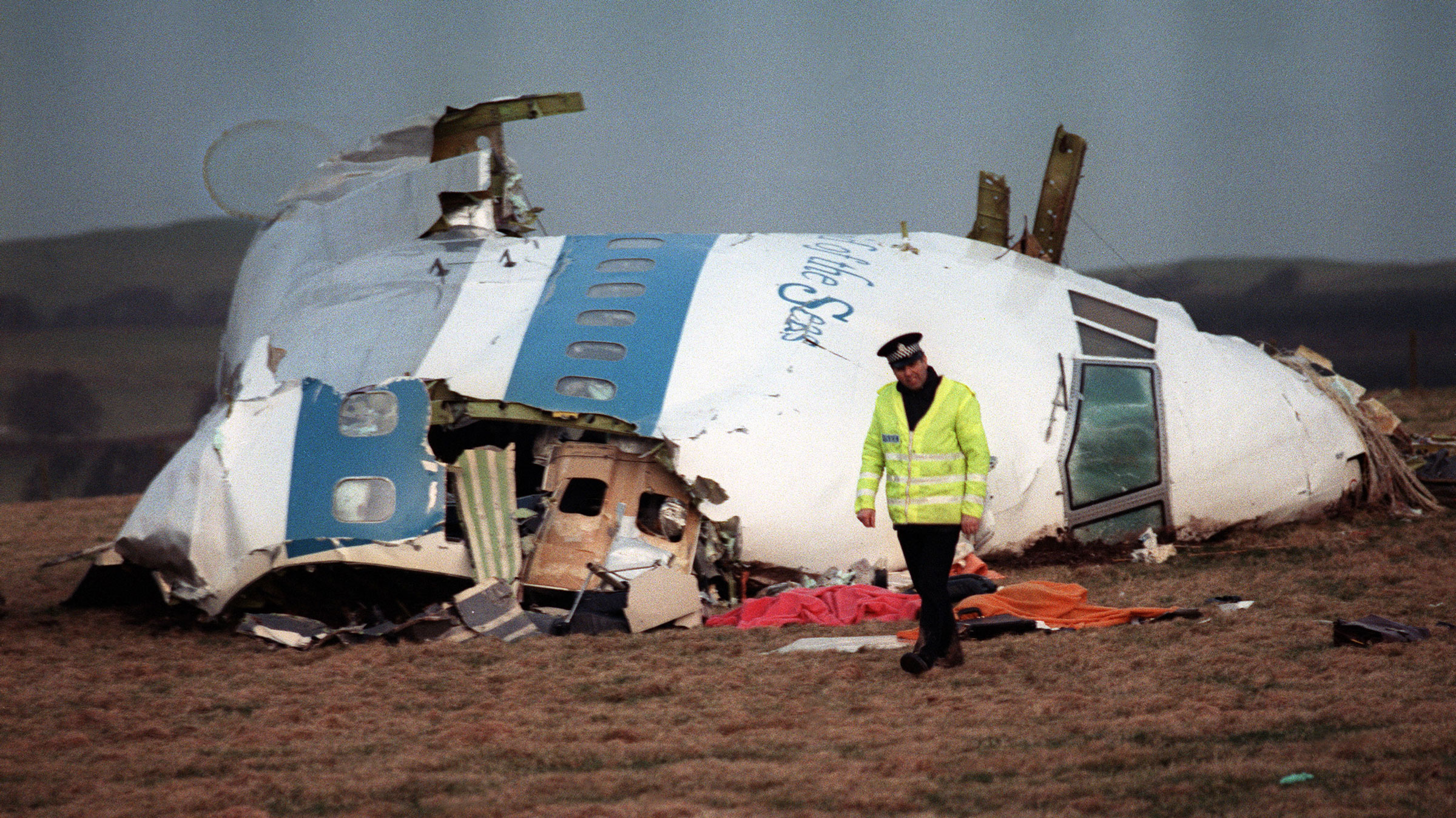 A police officer walks away from the wreckage of the jet that exploded and crashed over Lockerbie, Scotland, in 1988.