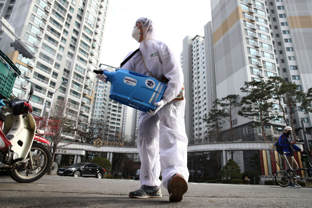 A worker sprays antiseptic solution against the coronavirus in Seoul yesterday.