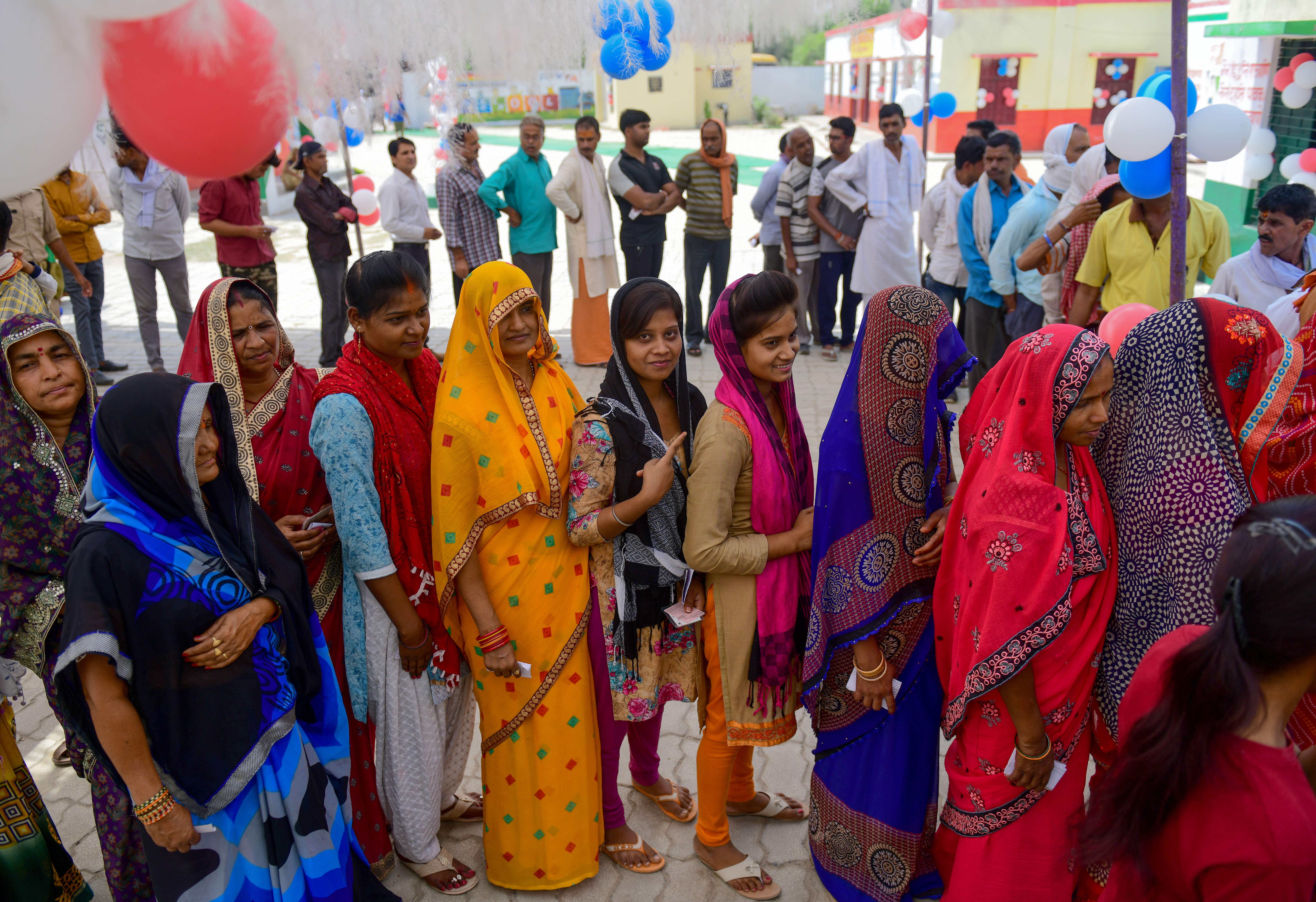 Voters queue at a polling station in Allahabad in Uttar Pradesh state on May 12, 2019.