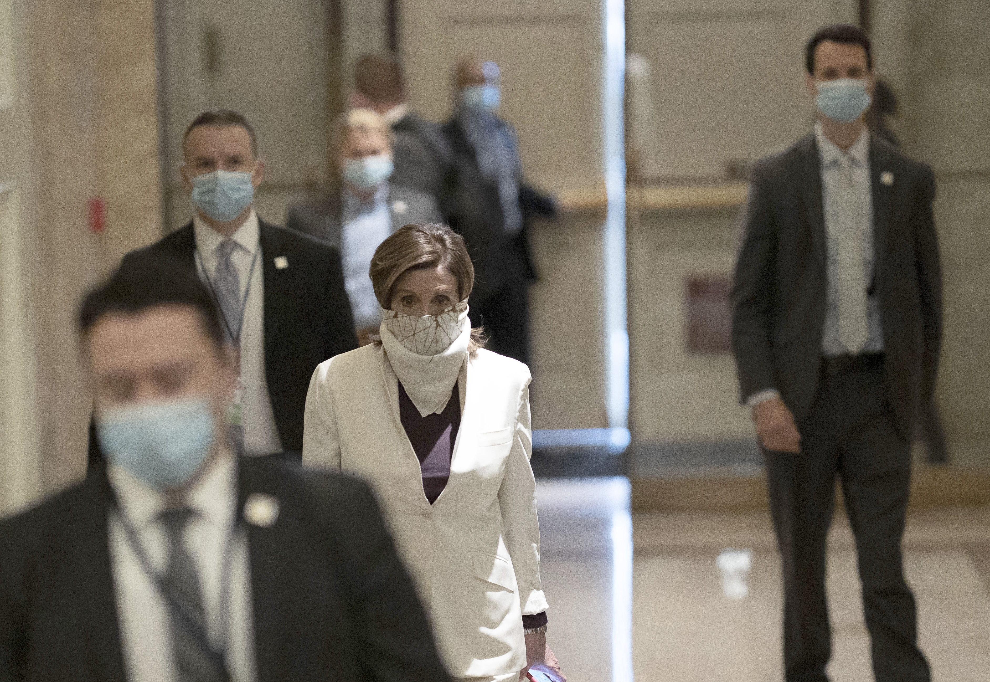 House Speaker Nancy Pelosi, in white, arrives at the US Capitol on April 23.