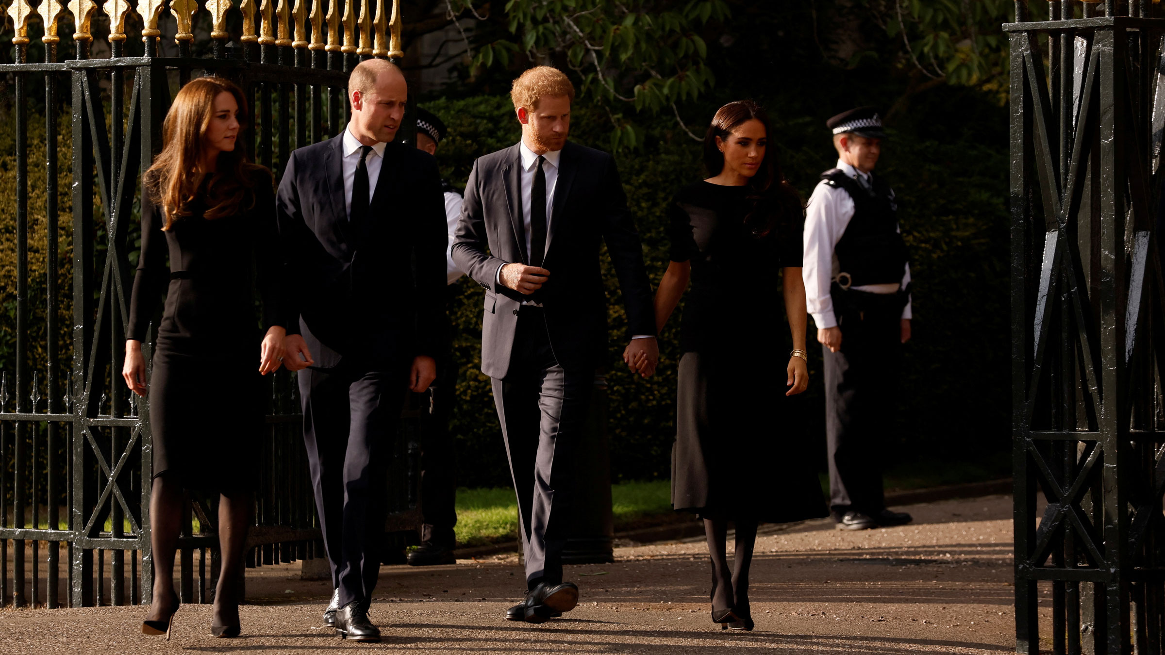 From left, Catherine, the Princess of Wales; Prince William; Prince Harry; and Meghan, the Duchess of Sussex, walk outside Windsor Castle on Saturday.