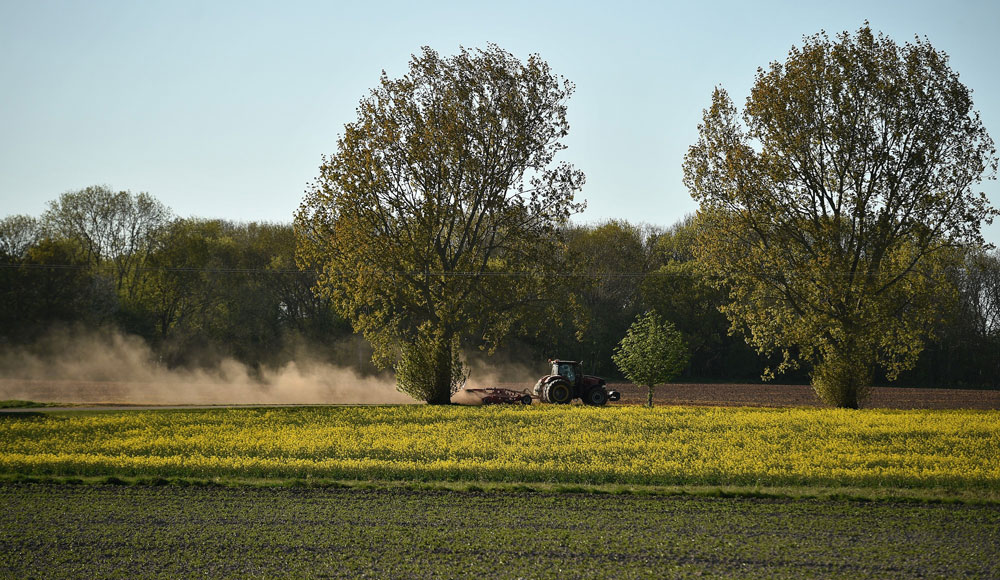 A farmer uses a tractor as he ploughs a field in Retford, near Lincoln in eastern England on April 20, as life in Britain continues during the nationwide lockdown to combat the coronavirus pandemic.