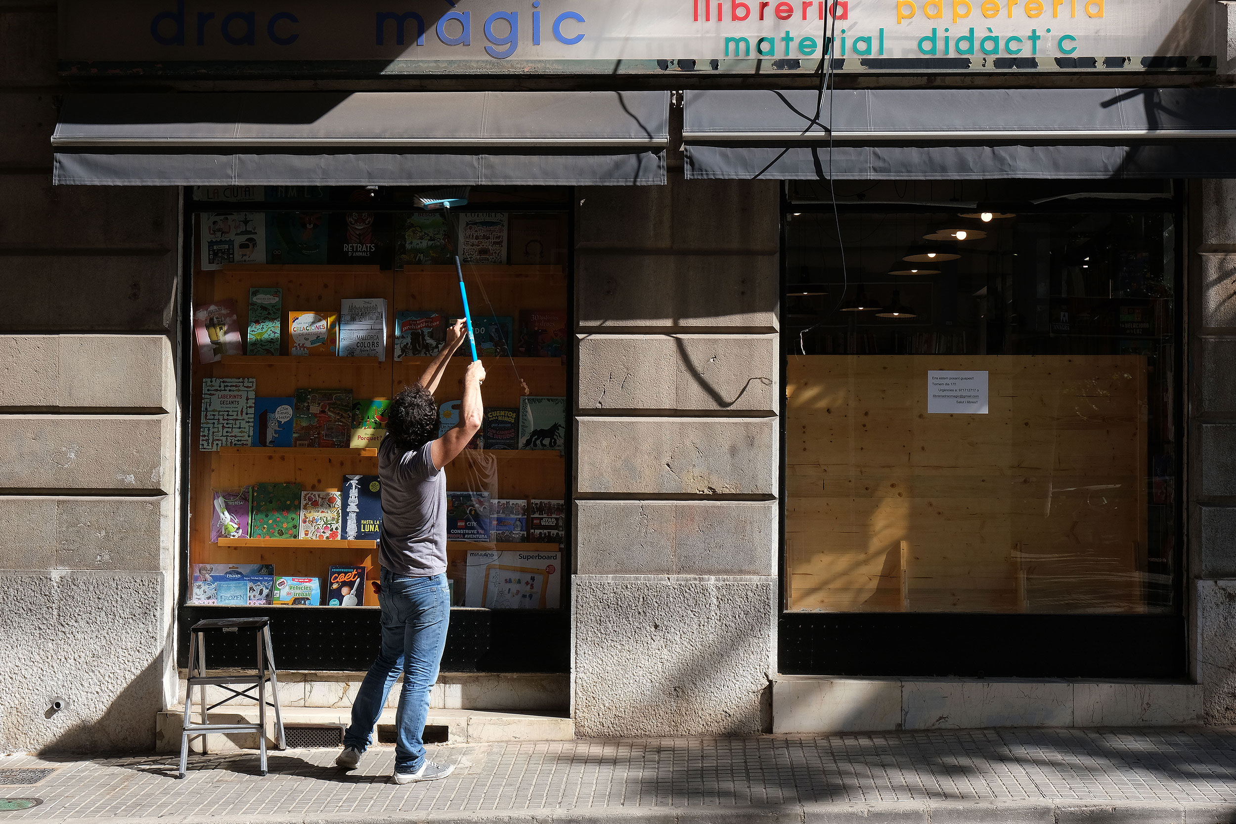 A woman opens her store in Palma de Mallorca during phase one of Spain's reopening. 