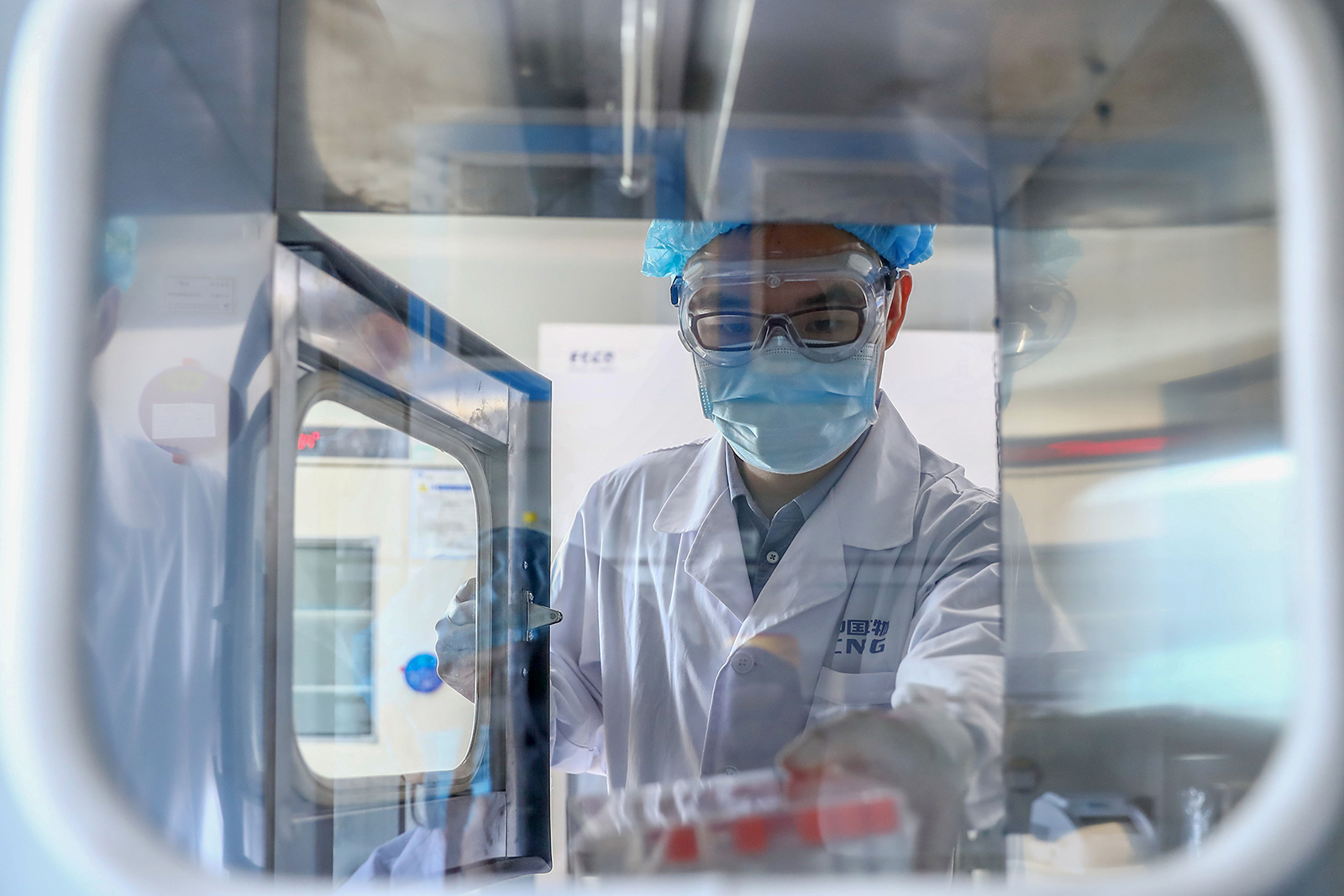 A staff member takes out samples of the Covid-19 inactivated vaccine at a vaccine production plant of China National Pharmaceutical Group Sinopharm, in Beijing, on April 11.