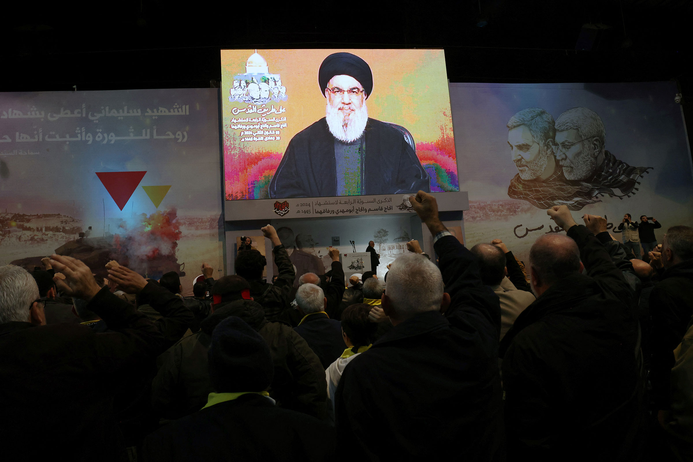 People watch the televised speech of Lebanon's Hezbollah chief Hassan Nasrallah to mark the anniversary of the killing of slain top Iranian commander Qasem Soleimani, in a Beirut's southern suburb on January 3.