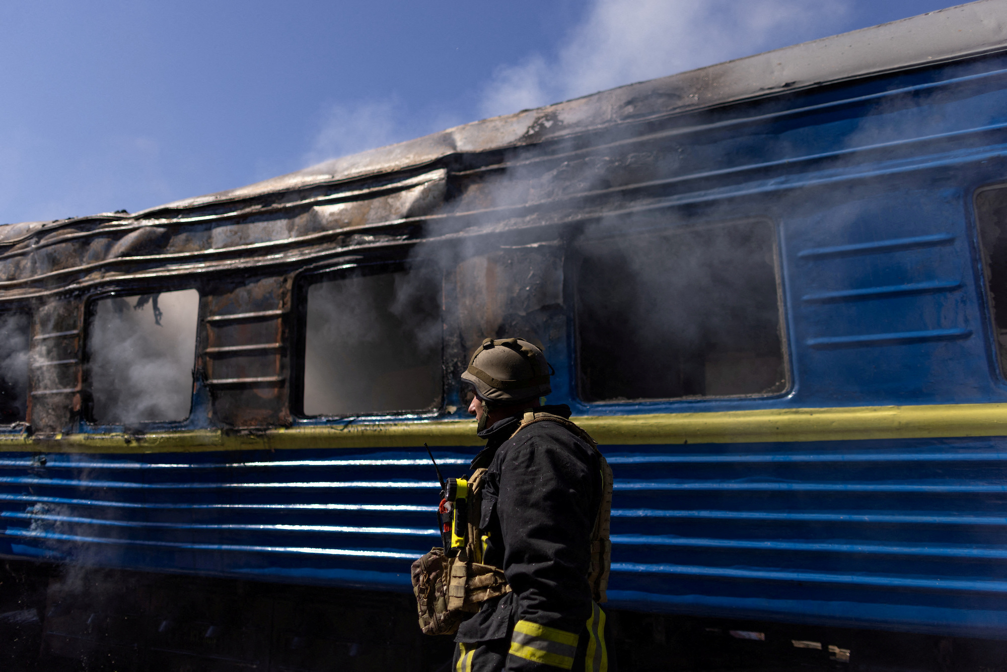 A firefighter works at the site of a train station hit by a Russian strike in Kherson on Wednesday.