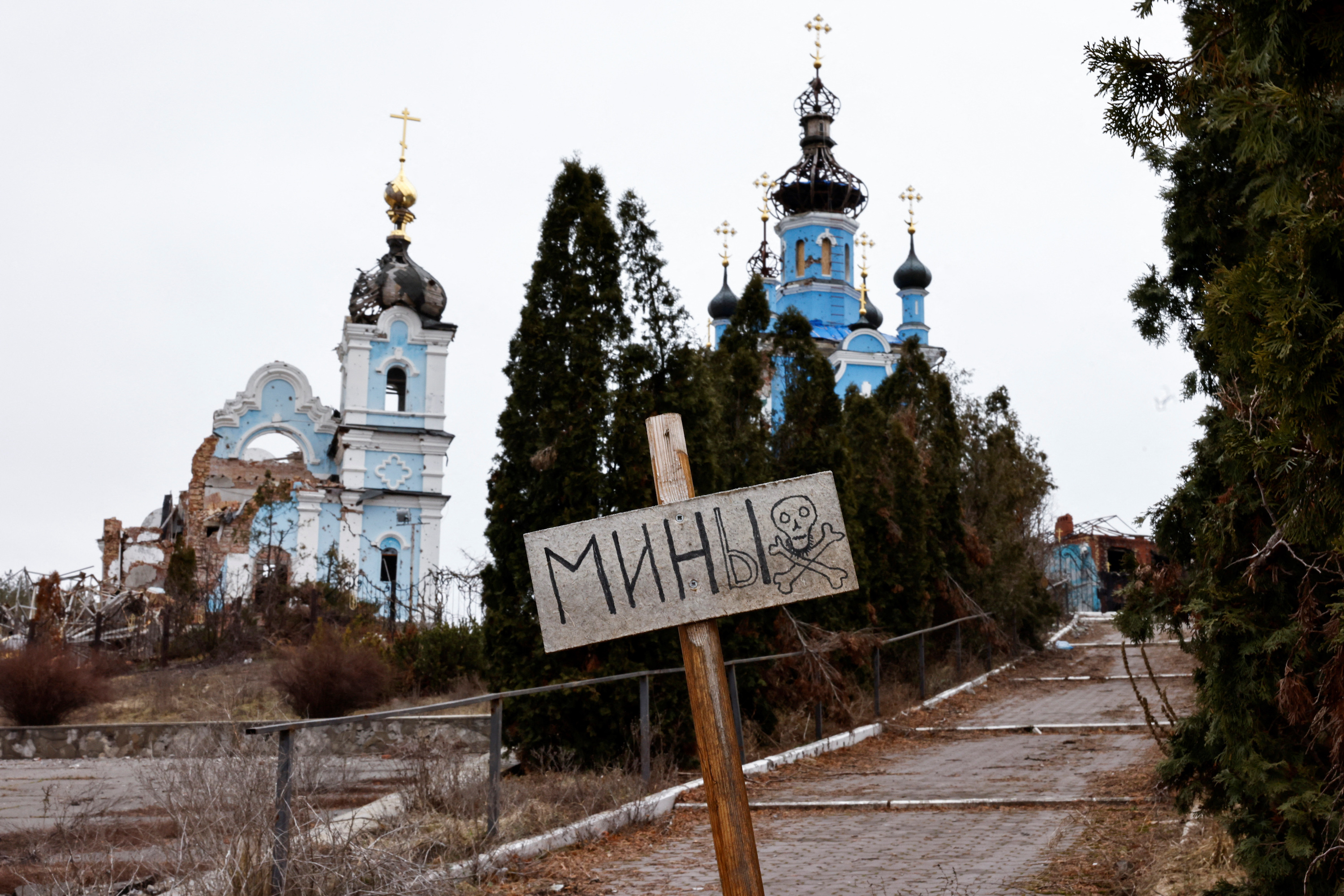 A sign warns of the presence of mines in the vicinity of the Orthodox Church of the Holy Mother of God Joy of All Who Sorrow, destroyed as a result of shelling in the village of Bohorodychne amid Russia's attack on Ukraine, in the eastern region of Donetsk, Ukraine March 18, 2023.