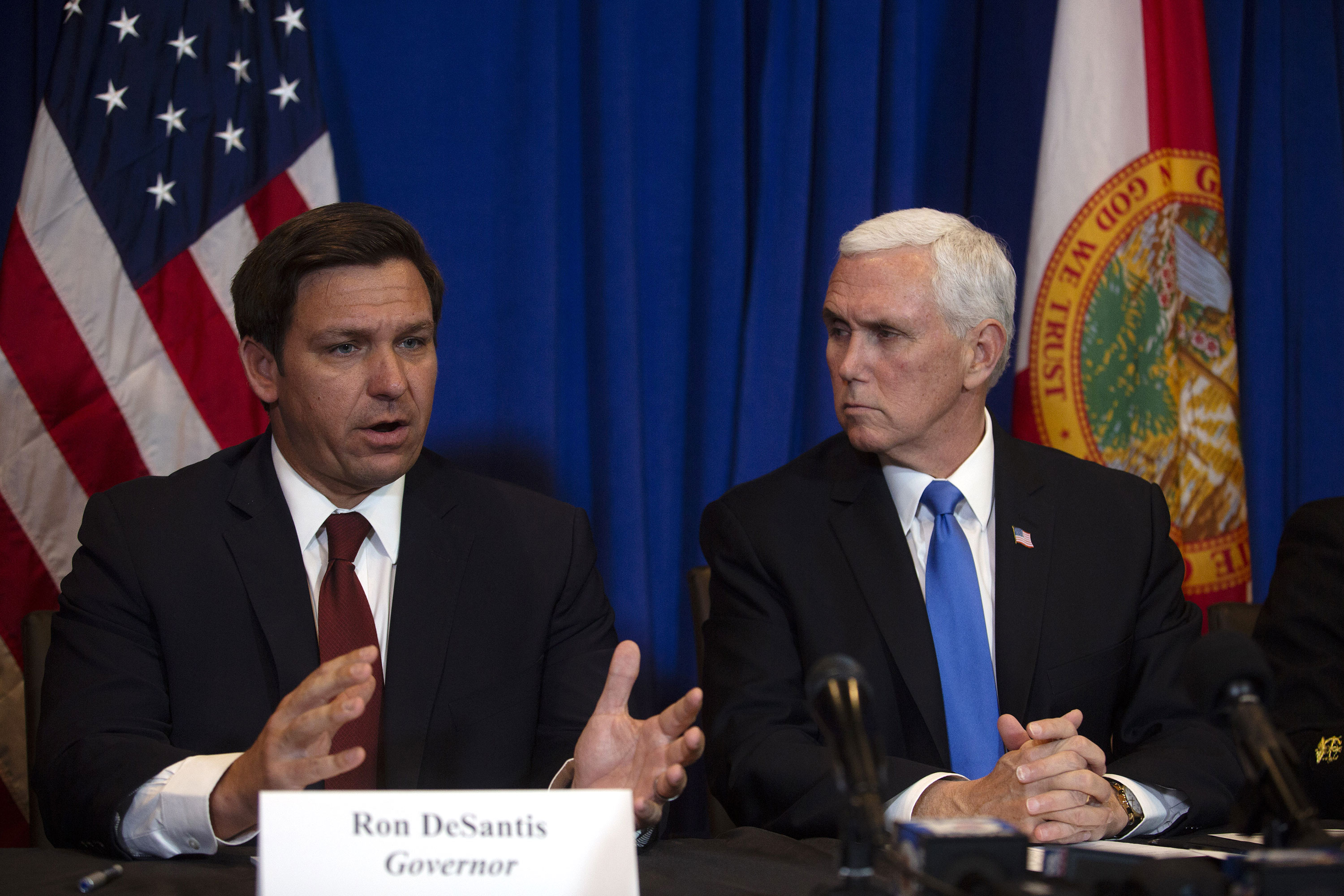 Gov. Ron DeSantis speaks while Vice President Mike Pence listens during a news conference in West Palm Beach, Florida, on Feruary 28.