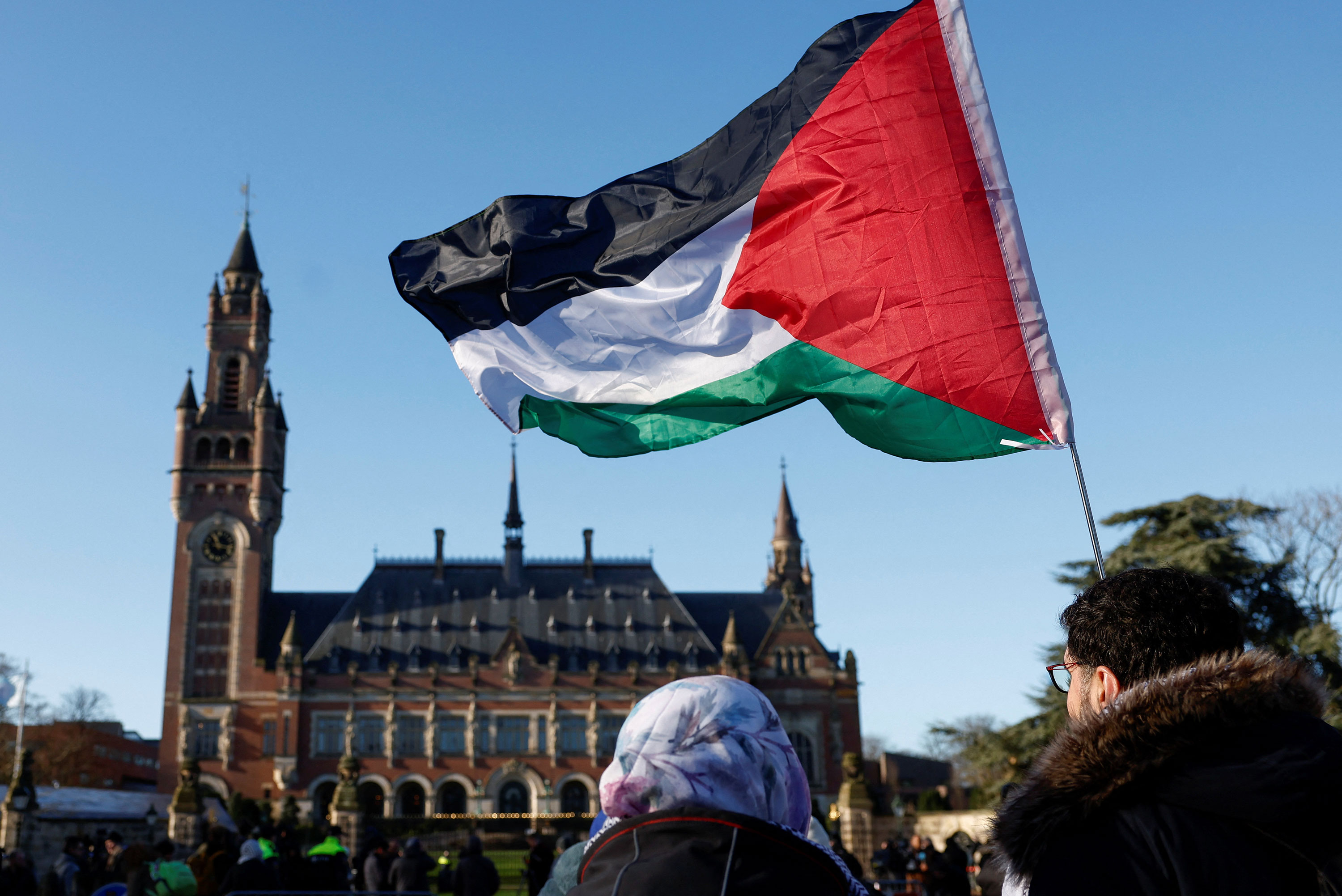Protesters hold a Palestinian flag outside the International Court of Justice in The Hague, Netherlands, on Friday.