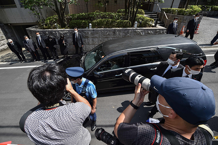 A car transporting the body of former Japanese prime minister Shinzo Abe arrives at his residence in Tokyo on Saturday, July 9