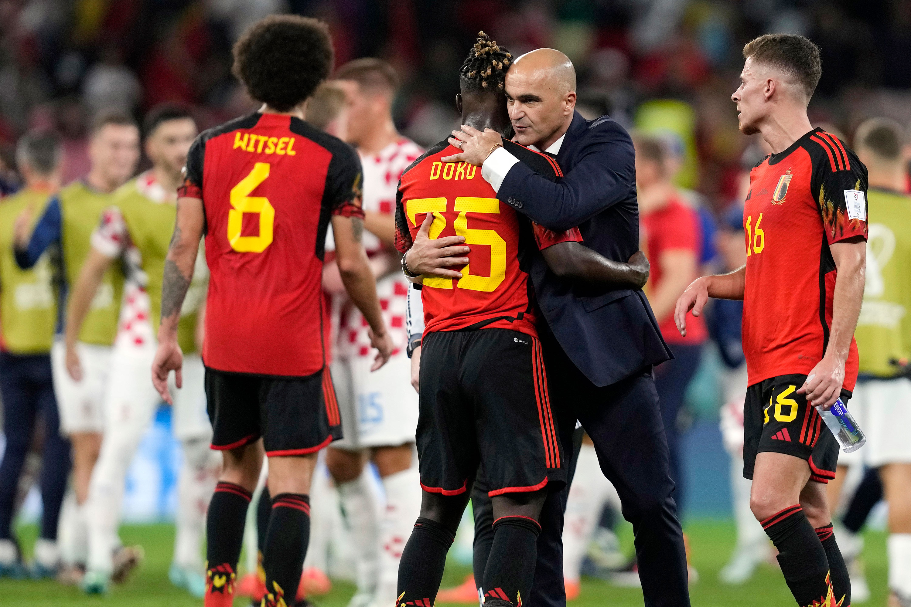 Belgium's head coach Roberto Martinez embraces Jeremy Doku after their match against Croatia.
