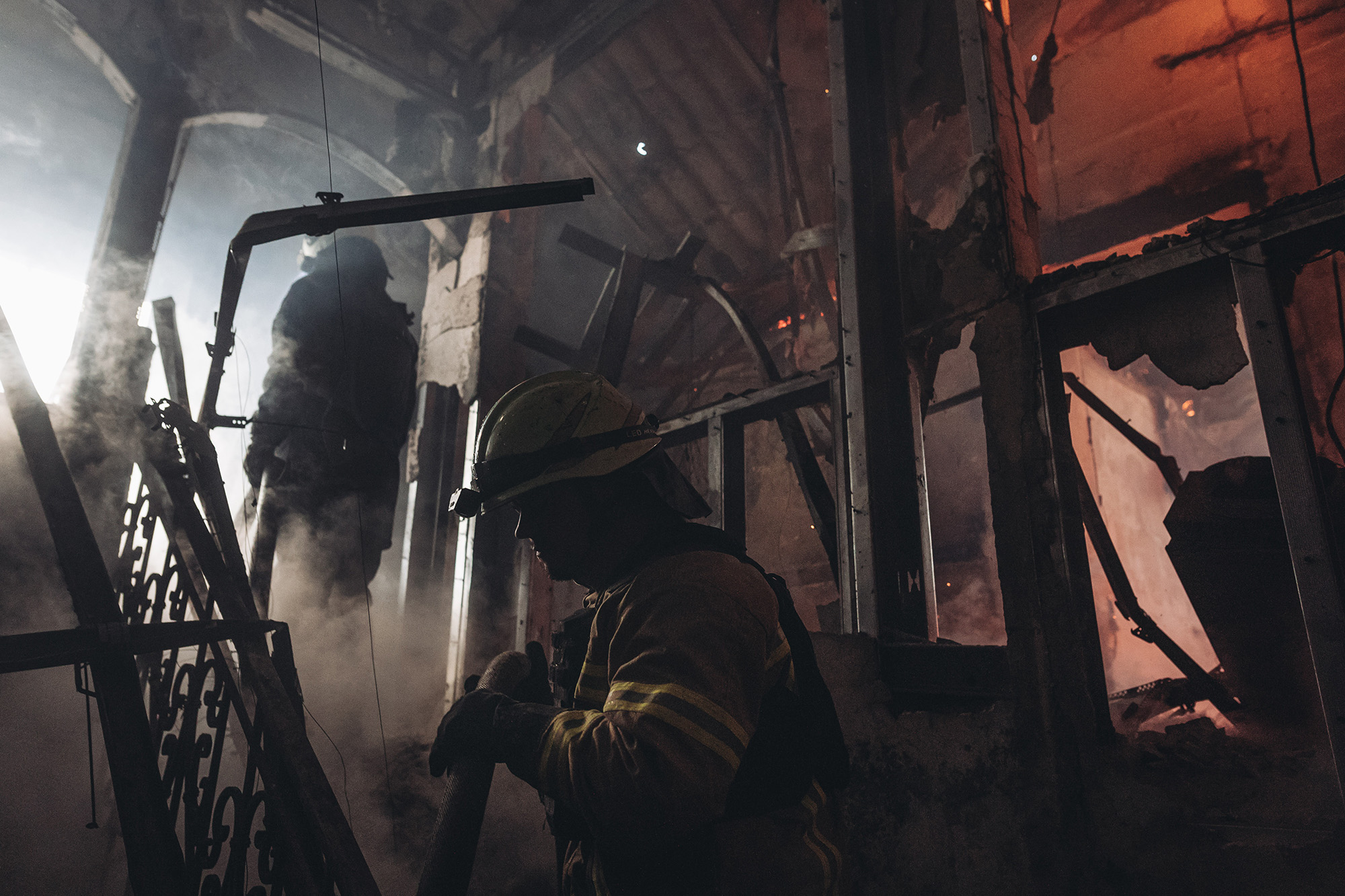 Firefighters extinguish a fire after Russian shelling in Bakhmut, Donetsk Oblast, Ukraine, on November 29.