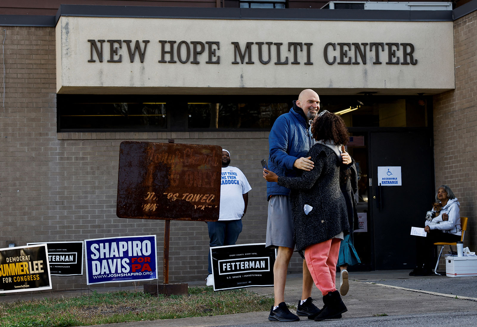 John Fetterman embraces a women outside of a polling location in Pittsburgh on November 8. 