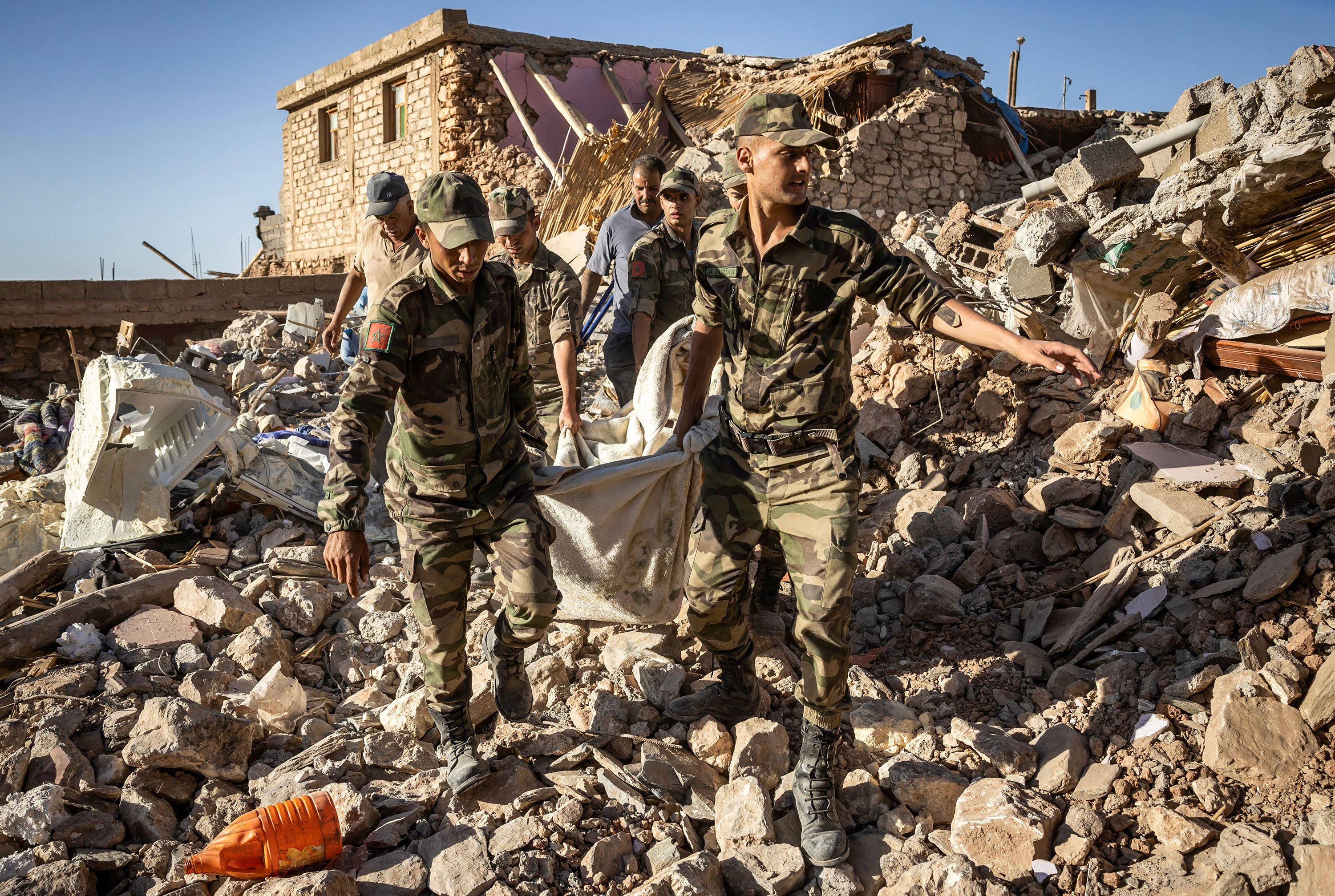 Moroccan Royal Armed Forces evacuate a body from a house destroyed by the earthquake in the mountain village of Tafeghaghte on September 9.