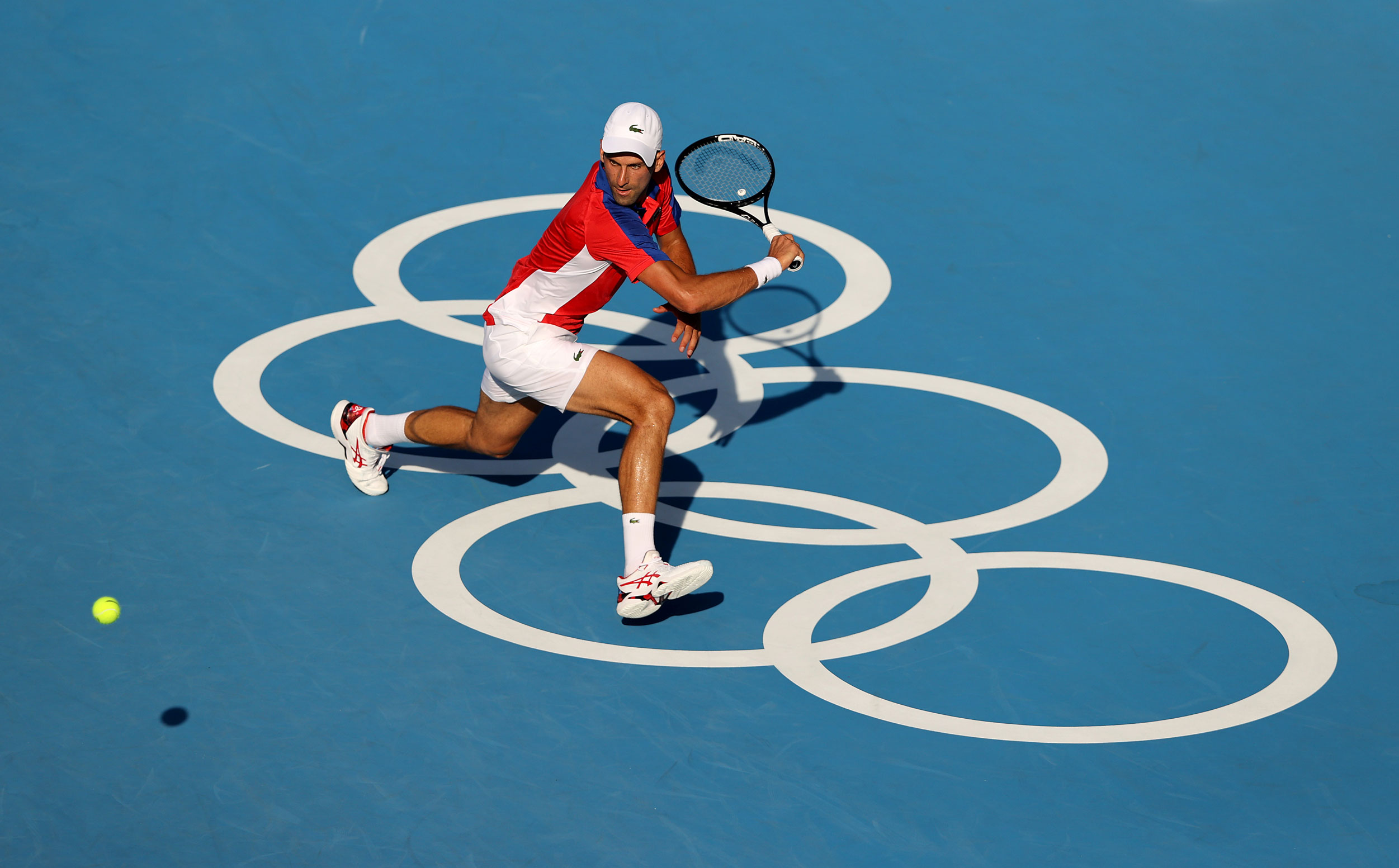 Serbia's Novak Djokovic plays a backhand during his Men's Singles First Round match against Bolivia's Hugo Dellien on July 24.