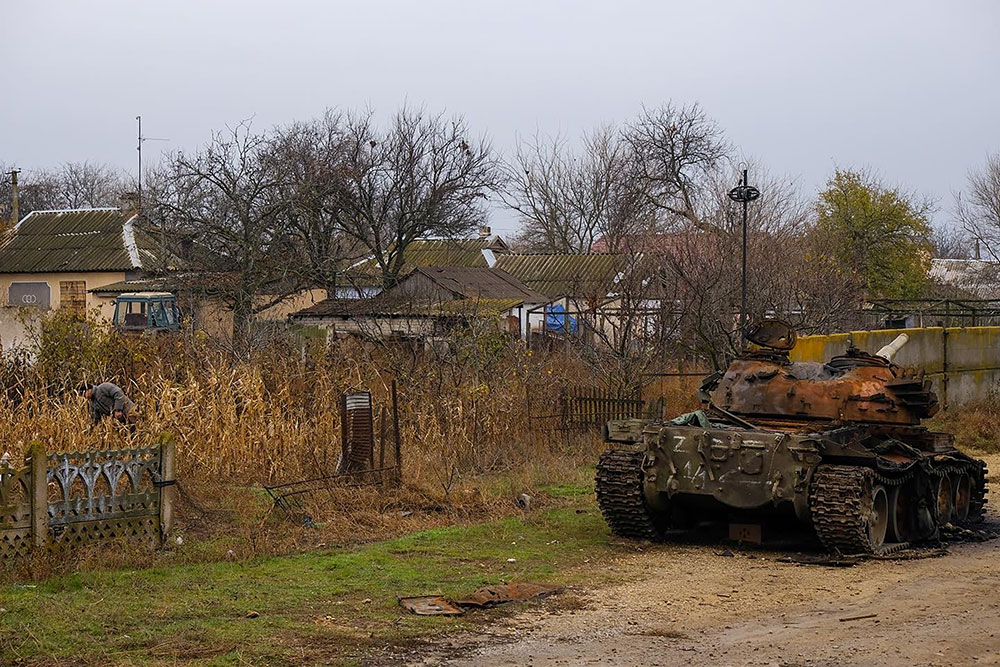 A Russian tank, destroyed when Kyiv's military forced Russian forces to retreat, sits on the side of the road.