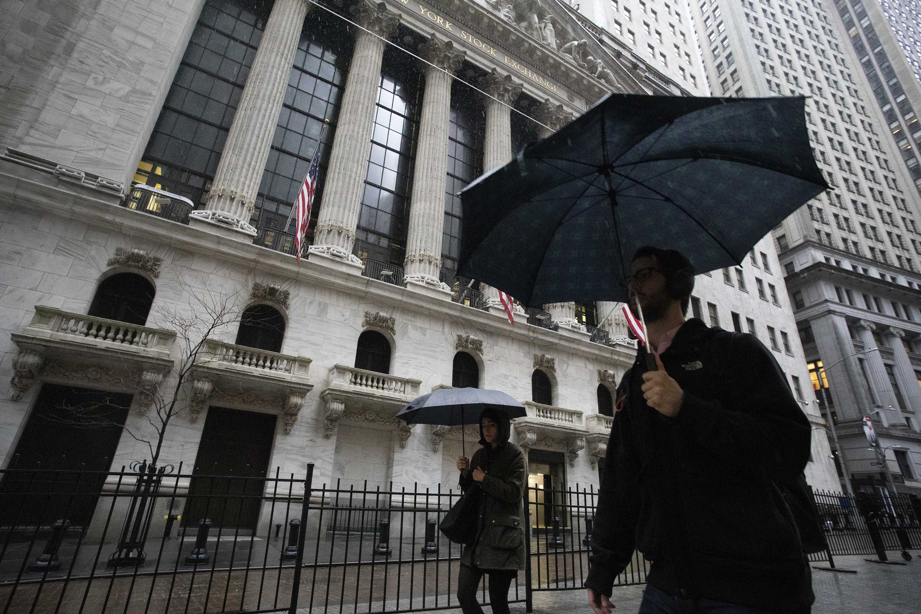 Pedestrians pass the New York Stock Exchange on Friday.