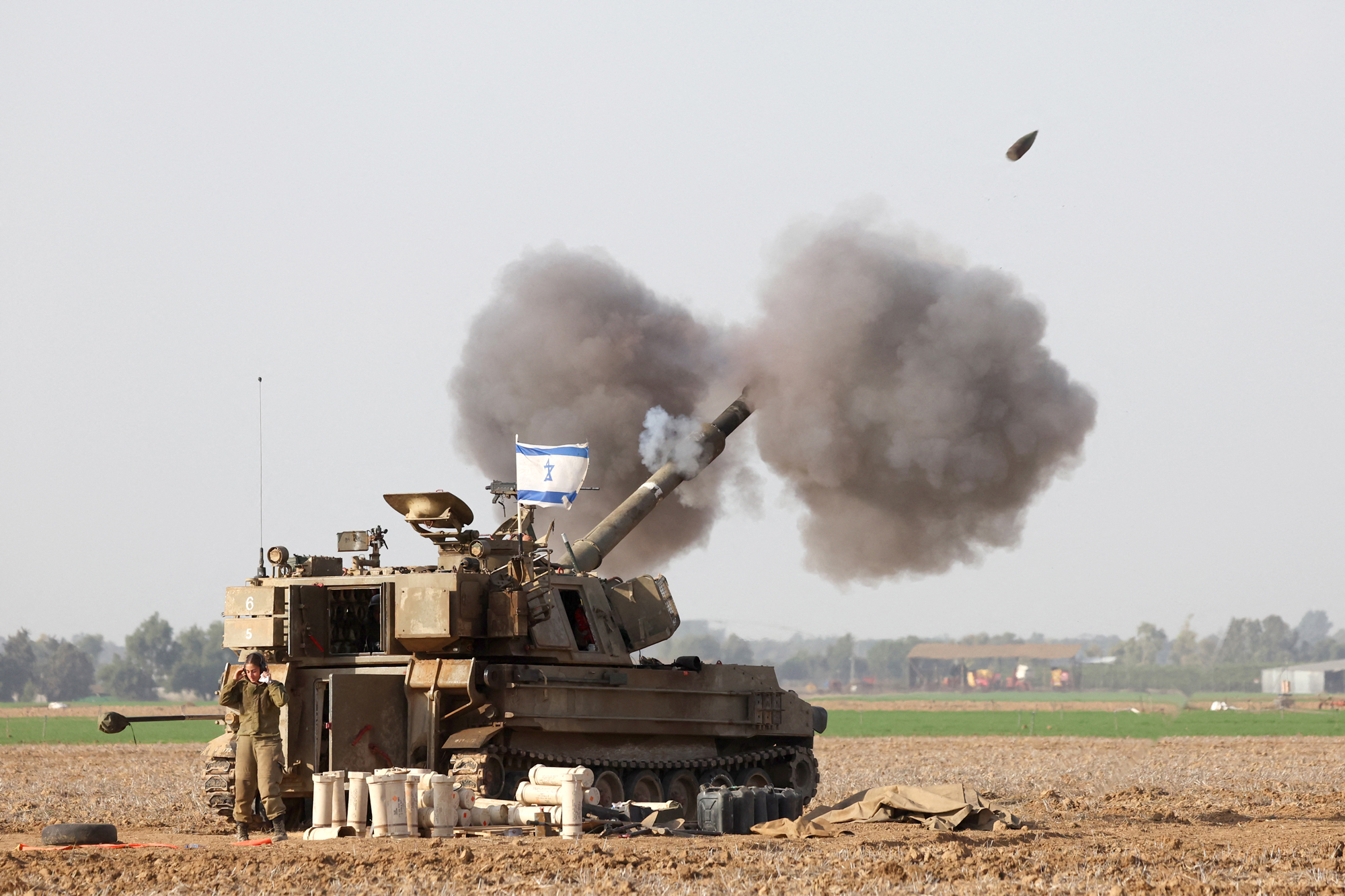 A picture taken in southern Israel near the border with Gaza on December 12 shows Israeli artillery firing towards Gaza.