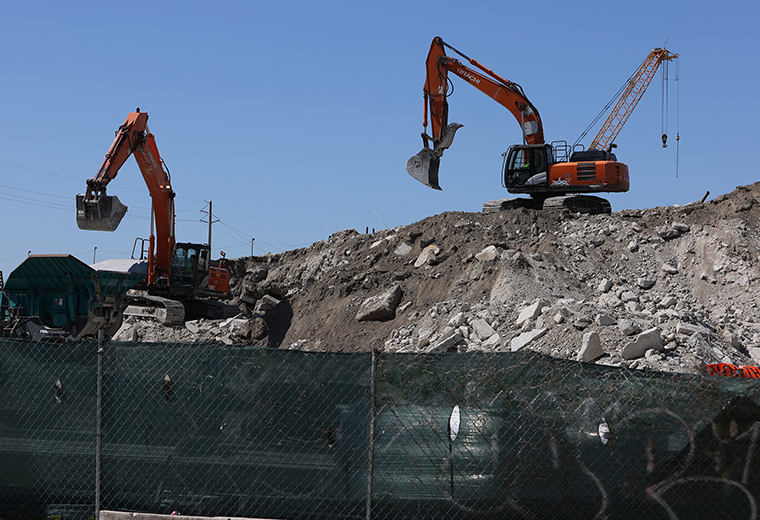 Construction workers build the “Signature Bridge,” replacing and improving a busy highway intersection at I-95 and I-395 on April 13, 2021 in Miami, Florida. 