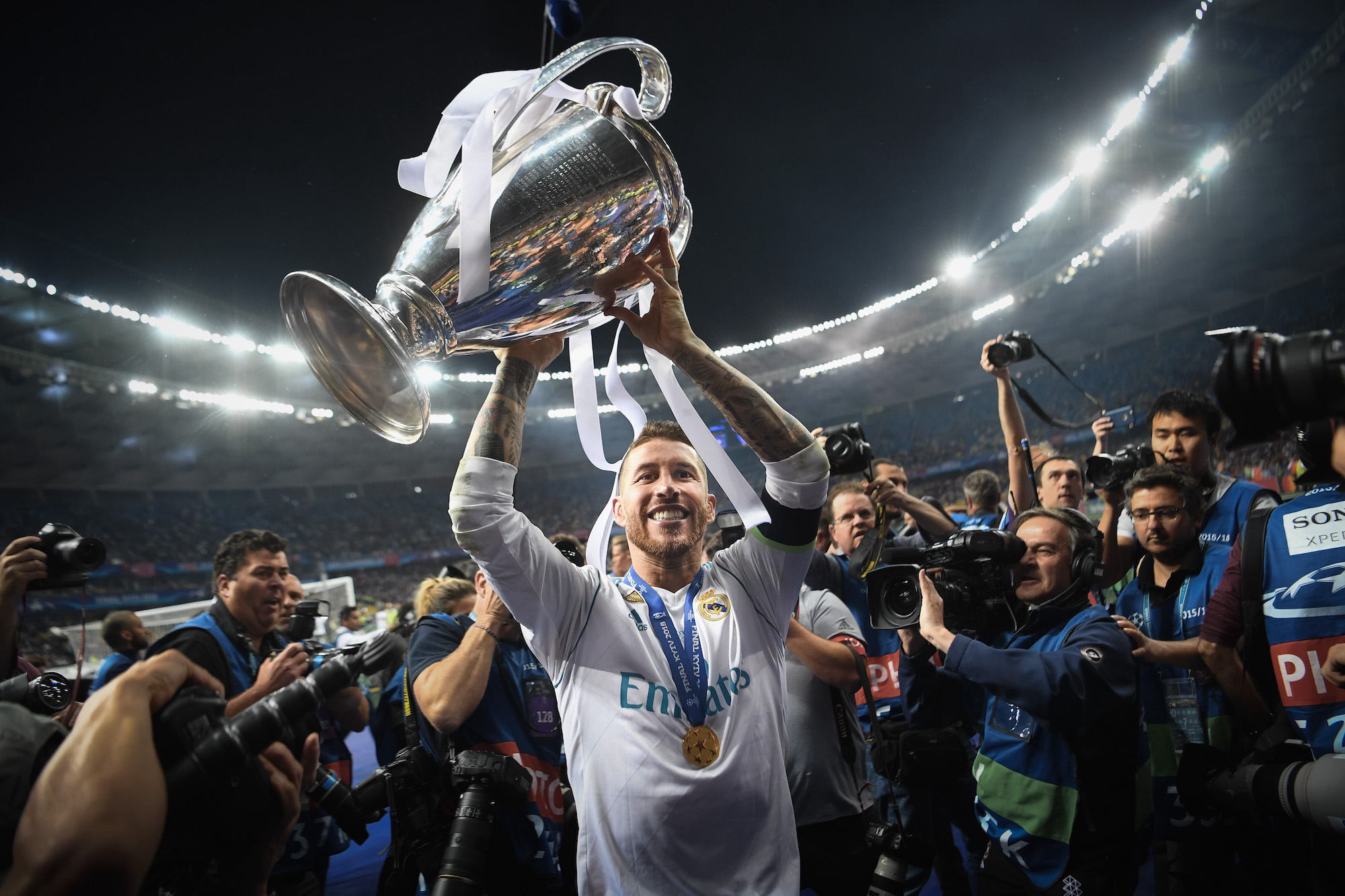 Then Real Madrid defender Sergio Ramos celebrates with the UEFA Champions League trophy following the final against Liverpool in Kyiv on May 26, 2018. It was Los Blancos' third consecutive European Cup - an unprecedented feat in the modern era.