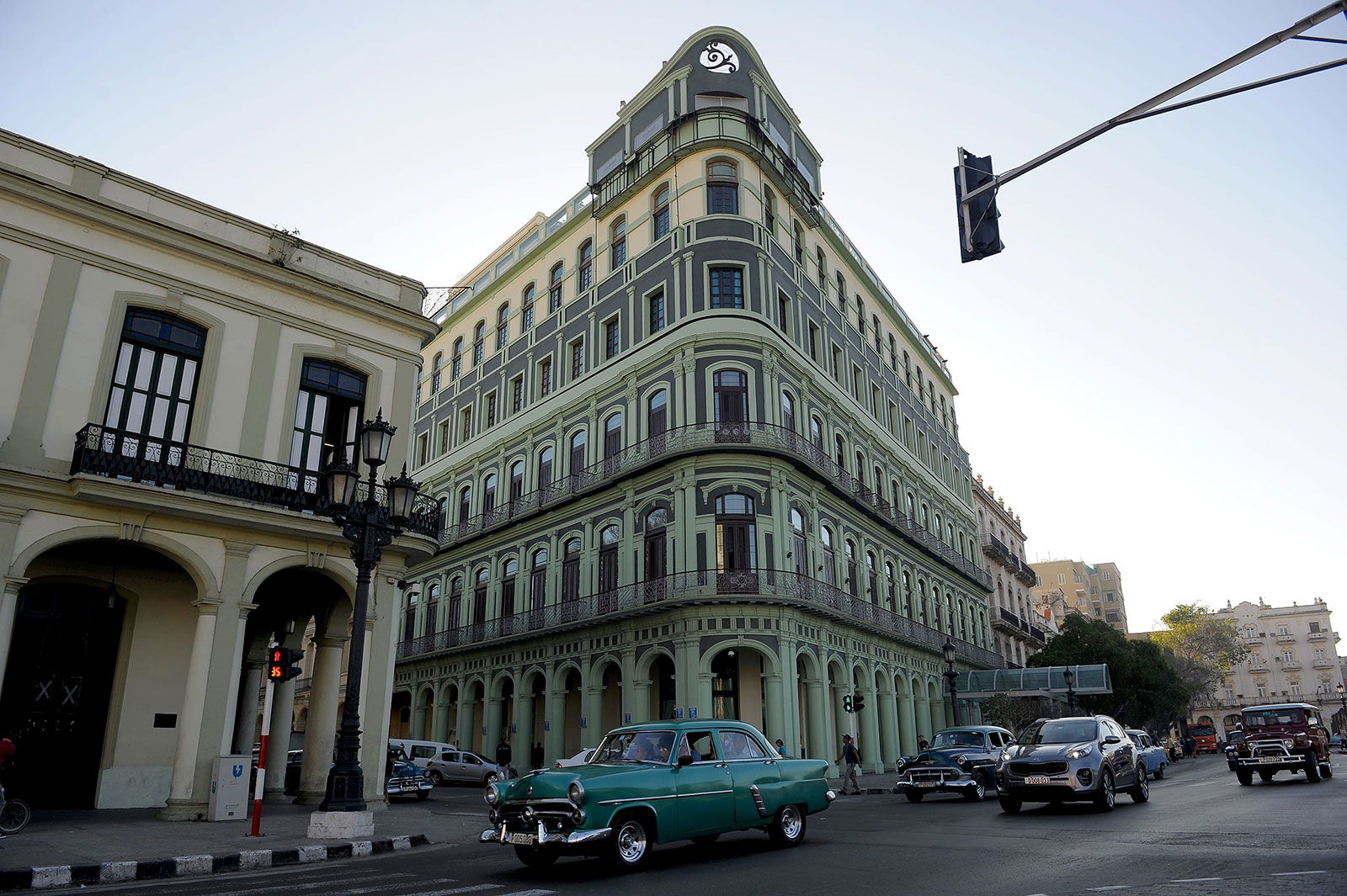 Cars drive past the Saratoga Hotel in Havana on January 26, 2017.