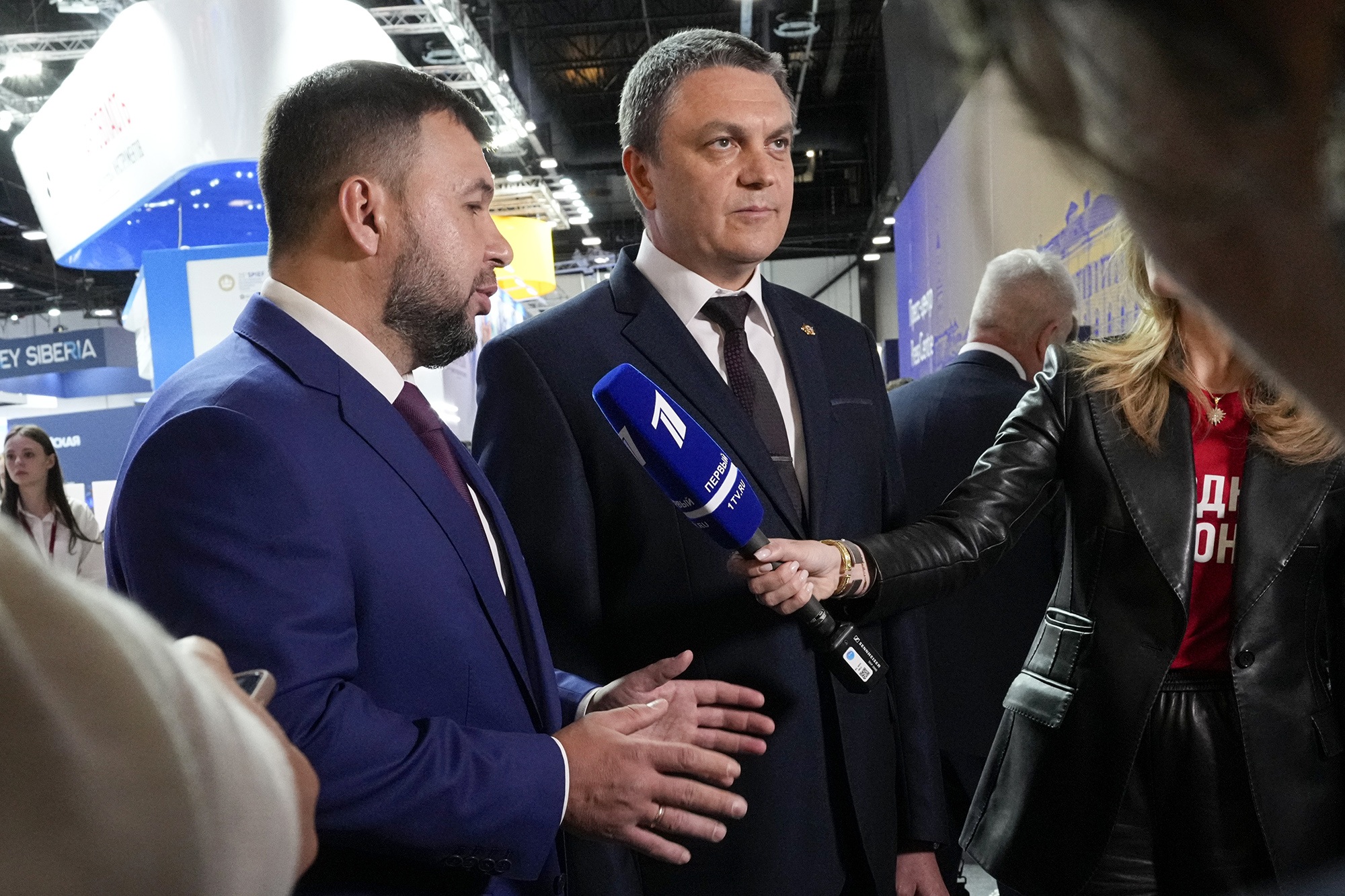 Denis Pushilin, leader of the Donetsk People's Republic, left, and Leonid Pasechnik, acting leader of self-proclaimed Luhansk People's Republic talk with journalists on the sidelines of the St. Petersburg International Economic Forum in St.Petersburg, Russia, on June 16.
