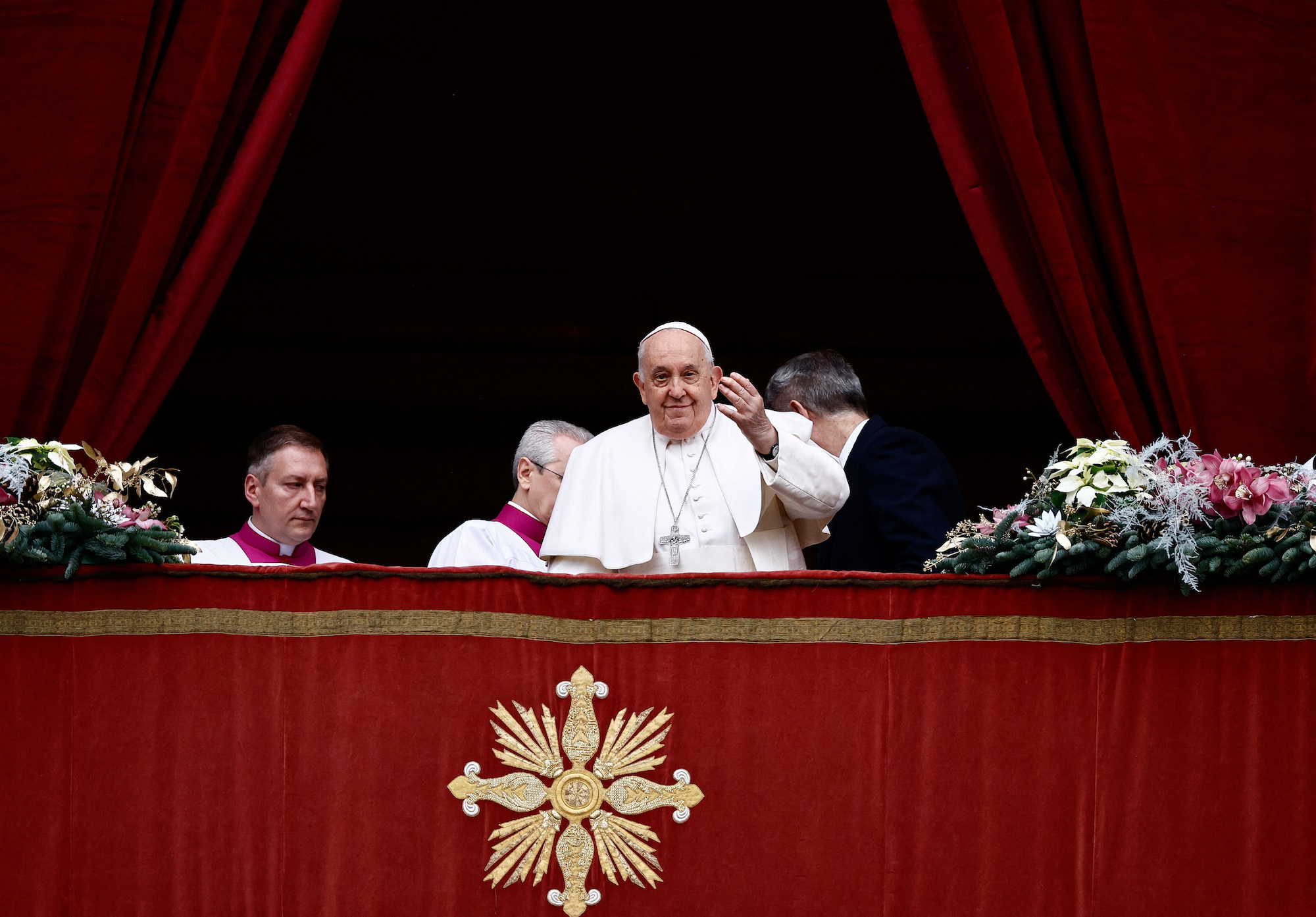 Pope Francis delivers his traditional Christmas Day message from the balcony of St. Peter's Basilica at the Vatican on Monday.