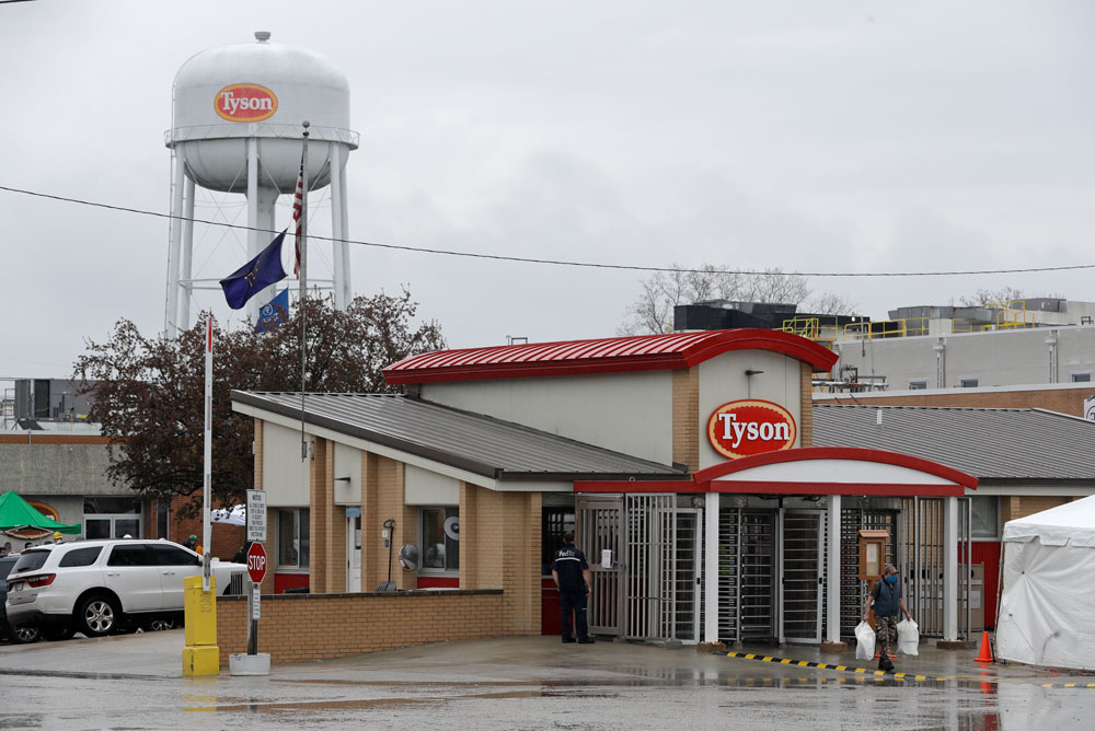 A Tyson Fresh Meats plant employee leaves the Logansport, Indiana, plant on Thursday, April 23. 