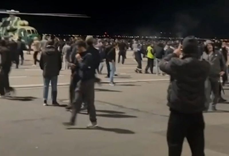 People crowd the tarmac at Makhachkala Uytash Airport in the southern Russian Republic of Dagestan on October 29.