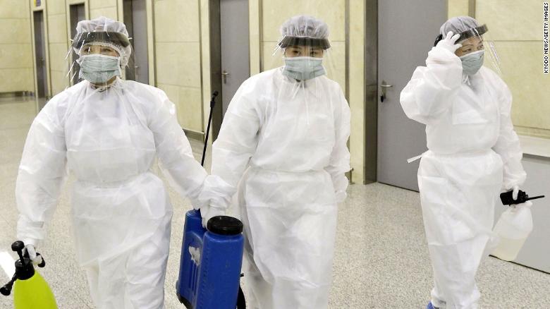 Quarantine staff in protective gear are pictured at Pyongyang International Airport.