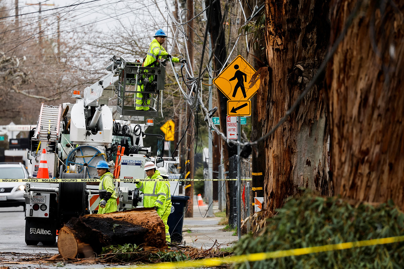 A Sacramento Municipal Utility District crew repairs downed power lines in Sacramento, California, on January 9.