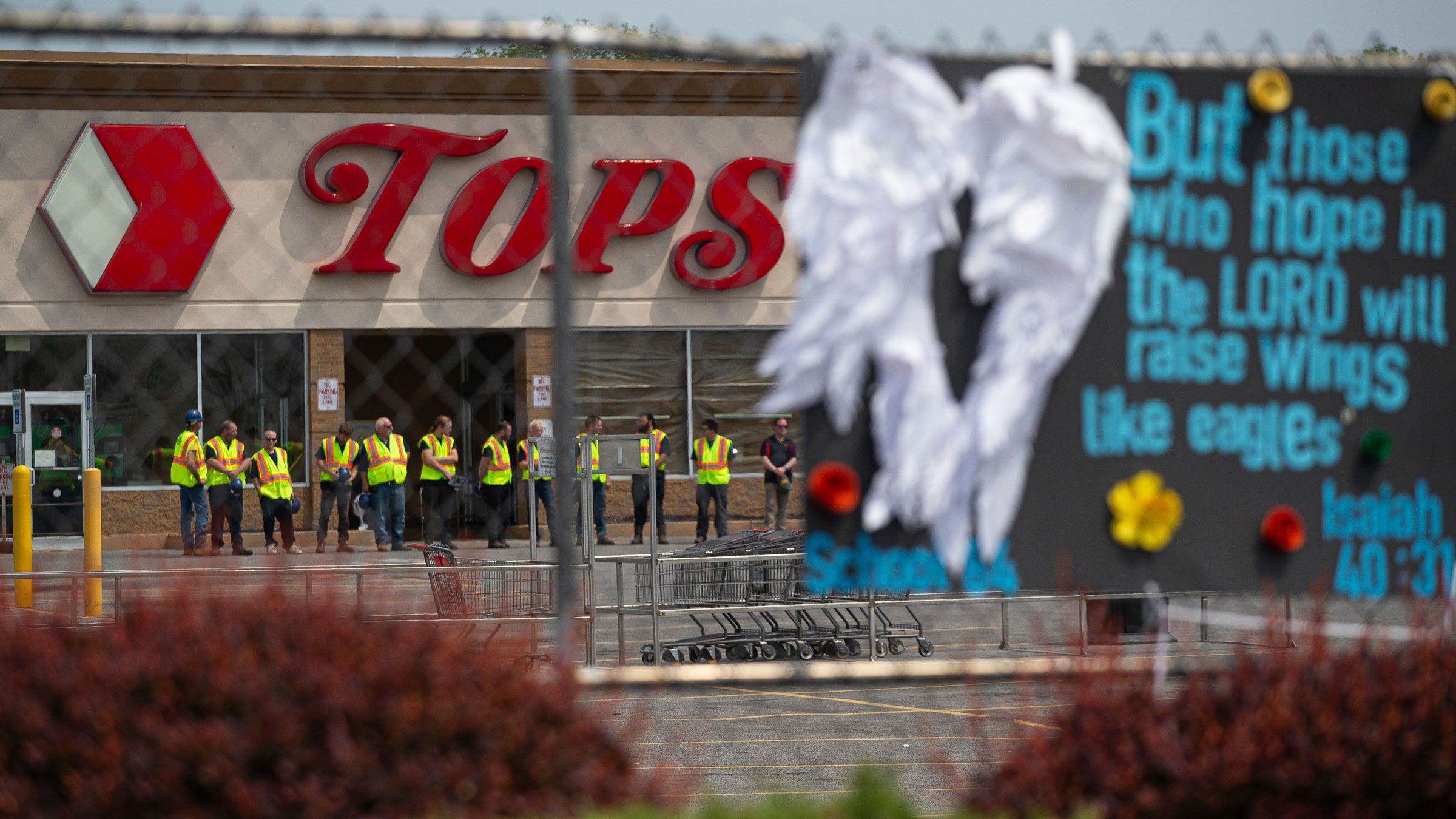 Investigators stand outside on May 21 during a moment of silence for the victims of the Buffalo supermarket shooting.