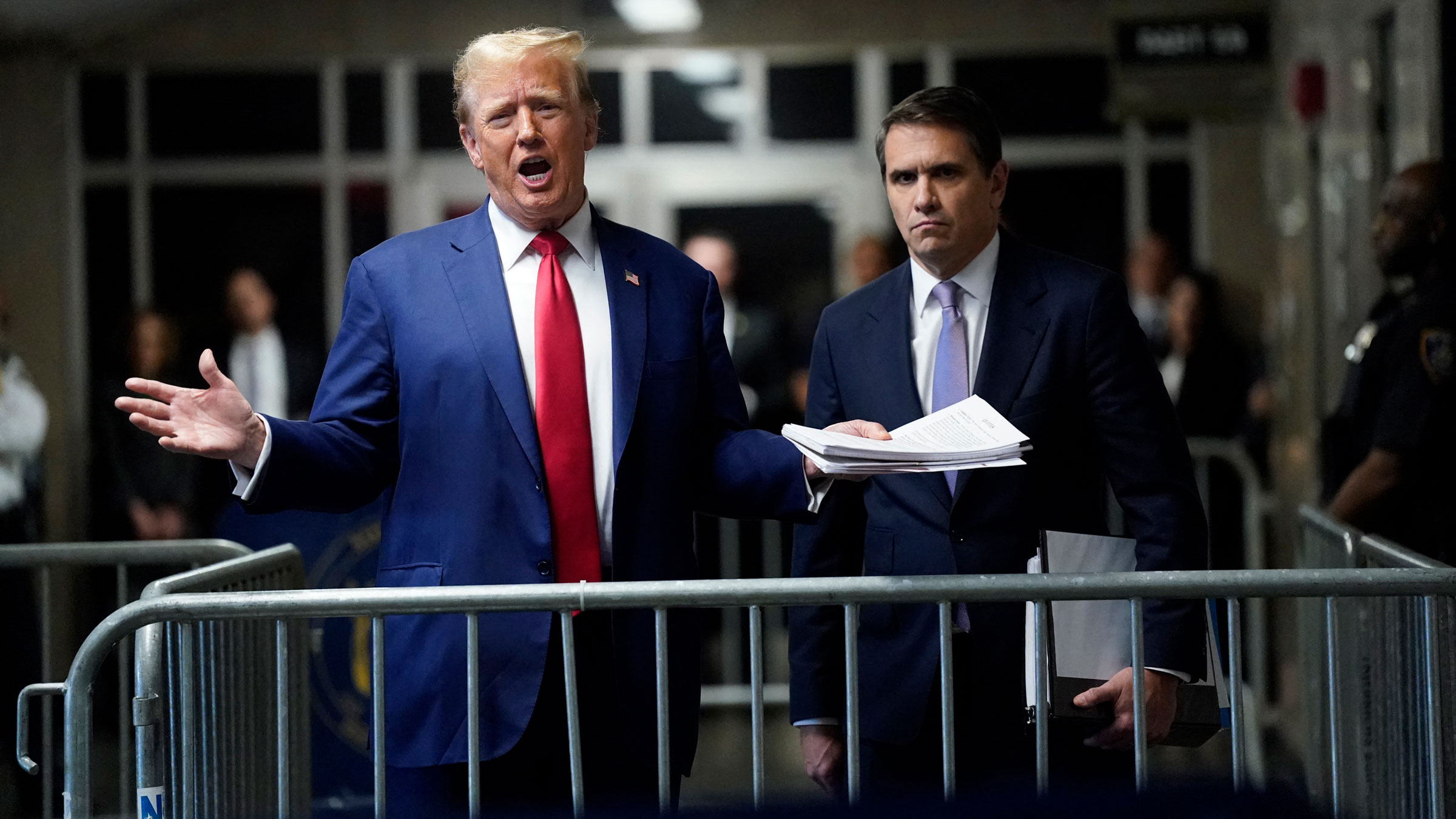 Former President Donald Trump, with attorney Todd Blanche, speaks to the press before leaving for the day Friday.