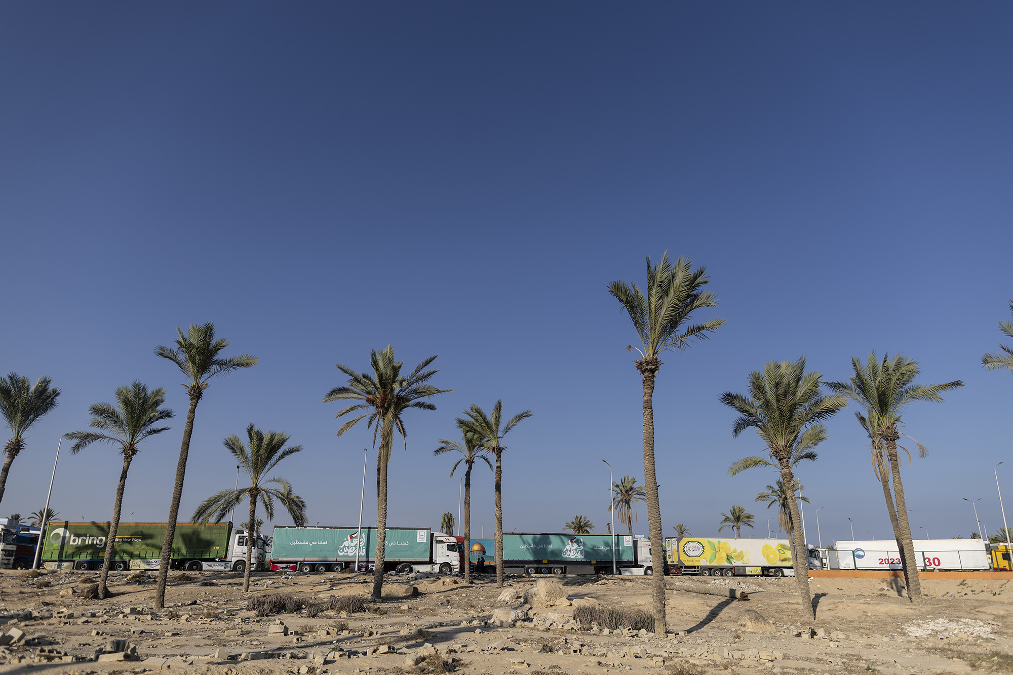 Aid convoy trucks loaded with supplies waiting to cross into Gaza at the Rafah border are seen on October 16, in North Sinai, Egypt. 